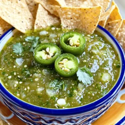 - 10 tomatillos, husked and rinsed - 1 jalapeño, stemmed and halved (or adjust to taste) - 1 small onion, quartered - 2 cloves garlic, peeled - 1/2 cup fresh cilantro, chopped - 1 tablespoon lime juice - Salt to taste - 1 tablespoon olive oil (optional, for smoother texture) To make a fresh and zesty salsa verde, use quality ingredients. Tomatillos are the star of this dish. They give salsa verde its bright green color and tangy flavor. Choose firm tomatillos with a vibrant green hue. Jalapeños add heat. You can adjust the amount based on your spice preference. If you want a milder salsa, you can use a green bell pepper instead. Onions bring sweetness and depth. A small onion works well here. Garlic adds a rich aroma and flavor. Always use fresh cloves for the best results. Fresh cilantro brings brightness and enhances the taste. Lime juice adds acidity and balances the flavors. Olive oil is optional but adds a nice smoothness. - Alternative ingredients for milder salsa: Use green bell peppers instead of jalapeños. This will keep the flavor fresh but reduce the heat. - Tips for selecting the freshest produce: Look for bright colors and firm textures. Check for blemishes or soft spots, as these can affect taste. - Seasoning variations: salt and beyond: Besides salt, you can experiment with cumin or black pepper for extra flavor. Using these tips will ensure your salsa verde is not only fresh but also tailored to your taste. For a complete guide on making this delicious dish, check out the Full Recipe. First, preheat your oven to 425°F (220°C). This step warms the oven and gets it ready for roasting. Next, take your tomatillos, jalapeño, onion, and garlic. Place them on a baking sheet. Make sure they are in a single layer. This helps them roast evenly. Roast the vegetables for about 15-20 minutes. Look for the tomatillos to turn slightly brown and feel soft. Once they look good, take them out and let them cool. Now, it’s blending time! In a blender, combine the roasted tomatillos, jalapeño, onion, and garlic. Add your chopped cilantro. Pour in the lime juice and sprinkle in salt to taste. If you like a smoother salsa, add a tablespoon of olive oil. Blend the mixture until you reach your desired texture. Do you want it smooth or chunky? You decide! Taste your salsa verde. If it needs more flavor, you can add extra lime juice or salt. Once it tastes just right, transfer it to a bowl. Let the salsa rest for at least 30 minutes. This waiting time allows the flavors to blend and get stronger. Enjoy your fresh and flavorful salsa verde! For the complete recipe, check out the Full Recipe section. To adjust the heat of your salsa, start with one jalapeño. If you want more heat, add another. For a milder salsa, remove the seeds from the jalapeño. This step reduces the spice. You can also use different peppers. For a fruity kick, try a poblano. If you prefer spice, use serrano peppers. Taste as you go to find your perfect balance. Making salsa verde ahead of time is easy and smart. After blending, let it sit for at least 30 minutes. This resting time helps the flavors mix well. If you prepare salsa a day early, it often tastes better. The ingredients marry and create a deeper flavor. Store it in an airtight container in the fridge. Salsa verde pairs well with many foods. Serve it with tortilla chips for a tasty snack. It also adds zing to tacos or grilled meats. You can drizzle it over eggs or use it in salads. For an exciting twist, mix it into pasta or grain bowls. Be creative; the options are endless! For the full recipe, check out [Full Recipe]. {{image_2}} You can add depth to your salsa verde by roasting extra ingredients. Try roasting bell peppers or even some corn. This gives a sweet and smoky taste. Just toss them on the baking sheet with your tomatillos and jalapeño. Roast them until they soften and get a bit of color. Then blend them with the other ingredients. The result? A rich and flavorful salsa that stands out. If tomatillos are hard to find, green tomatoes work well. They provide a similar tangy taste. Just chop them and use them in place of tomatillos. The process remains the same. Roast, blend, and season. This variation adds a unique twist, keeping the taste fresh and exciting. For a creamy texture, blend in ripe avocado. Just add half of an avocado to the blender when mixing your salsa. This makes the salsa smooth and rich. It also adds healthy fats, making it more filling. This variation is great for those who love a creamy dip. Plus, it pairs well with chips or as a topping on tacos. Check out the Full Recipe for more details and tips to make your salsa verde shine! To keep your salsa verde fresh, use an airtight container. Glass jars work best. They seal tightly and let you see the bright green color. Plastic containers are fine too, but ensure they are food-safe. After you make the salsa, let it cool to room temperature. This step avoids condensation in your container. Once cool, transfer it to your chosen container. Store it in the fridge. Homemade salsa verde lasts about one week in the fridge. It should stay fresh if stored properly. For longer storage, consider freezing it. Pour your salsa verde into freezer-safe bags or containers. Leave some space at the top, as it will expand when frozen. Salsa verde can last up to six months in the freezer. When you want to use it, thaw it overnight in the fridge. You can also run warm water over the bag if you need it faster. Avoid refreezing, as it may change the texture and taste. For the full recipe, check out the provided link. Salsa verde is a green sauce made from tomatillos. It has a bright, tangy taste. You can use it in many ways. Serve it with tortilla chips, tacos, or grilled meats. It adds a fresh kick to any dish. You can also use it as a marinade or dressing. Yes, you can make salsa verde without a blender. Use a mortar and pestle to mash the ingredients. You can also chop everything finely by hand. This method gives a rustic texture. It may take a bit longer, but it works well. Just be sure to mix the ingredients thoroughly for even flavor. If your salsa verde tastes too acidic, try adding a pinch of sugar. This will help balance the acidity. Another option is to add more salt. You can also mix in extra cilantro or diced avocado. These added ingredients will mellow the sharpness. Taste and adjust until you love it! Homemade salsa verde is simple and fun to make. With key ingredients like tomatillos, jalapeños, and cilantro, you can create a fresh, vibrant dish. Adjust the spice to your taste and experiment with different ingredients for unique flavors. Remember, a little resting time enhances the taste. Store any extras properly for later enjoyment. I hope these tips help you whip up your own salsa verde successfully. Enjoy it as a dip or a flavorful sauce in your meals!