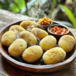 - 2 large potatoes, peeled and diced - 250g ground beef - 1 medium onion, finely chopped - 2 cloves garlic, minced - 1 tablespoon soy sauce - 1 tablespoon sweet soy sauce (kecap manis) - 1 teaspoon ginger paste - 1 teaspoon coriander powder - ½ teaspoon turmeric powder - Salt and pepper to taste - 1 cup breadcrumbs - 2 eggs, beaten - Cooking oil for frying To make easy Indonesian beef potato croquettes, you need fresh ingredients. Start with two large potatoes. Peel and dice them. Potatoes give the croquettes a creamy texture. Next, use 250 grams of ground beef. This adds a savory flavor. Chop one medium onion finely. Mince two cloves of garlic. These aromatics make your croquettes smell great. Then, gather your sauces. You will need one tablespoon of soy sauce and one tablespoon of sweet soy sauce. These will bring out the rich flavors. Spices are key too. You’ll need one teaspoon of ginger paste, one teaspoon of coriander powder, and half a teaspoon of turmeric powder. They give the croquettes a warm, spicy kick. Lastly, don’t forget salt and pepper to taste. You also need one cup of breadcrumbs to coat the croquettes, two beaten eggs for binding, and cooking oil for frying. For the full recipe, check the details above. This blend of ingredients will help you create delicious croquettes that everyone will love. First, you need to boil the potatoes. Place the diced potatoes in a pot with salted water. Bring the water to a boil and cook for about 15 minutes. The potatoes should feel soft when pierced with a fork. Drain the potatoes and mash them until smooth. Set the mashed potatoes aside to cool. This step is key to making your croquettes fluffy and light. Next, it’s time to cook the beef. Heat a skillet over medium heat and add a splash of oil. Sauté the chopped onion until it turns translucent. This usually takes about 3 minutes. Then, add the minced garlic and ginger paste to the skillet. Cook for another 2 minutes until they smell great. Now, add the ground beef and cook it until it is browned. This should take about 5 minutes. Stir in the soy sauce, sweet soy sauce, coriander powder, turmeric powder, salt, and pepper. Let this mixture cook for another 5 minutes to blend all the flavors. Once done, remove it from heat and let it cool slightly. When both the mashed potato and beef mixture are cool enough to handle, combine them in a large bowl. Mix well until everything is evenly combined. Now, shape the mixture into round or oval croquettes, about the size of a golf ball. Dip each croquette into the beaten eggs, coating it fully. Then, roll it in breadcrumbs until it is nicely covered. Heat oil in a deep skillet over medium-high heat. Fry the croquettes in small batches until they are golden brown and crispy. This takes about 3-4 minutes per side. After frying, use a slotted spoon to transfer them to a paper towel-lined plate to drain any excess oil. Enjoy your delicious croquettes! For the full recipe, check the details above. To create the best Indonesian beef potato croquettes, focus on texture and flavor. Start with starchy potatoes like Russets. They give a fluffy, creamy mix. Mash them well to avoid lumps. Always taste the beef mixture before forming croquettes. Adjust your seasoning with salt and pepper. A well-seasoned filling makes a big difference. Control the temperature when frying. Heat your oil to about 350°F (175°C). If it's too hot, the outside will burn before the inside cooks. Fry in small batches to keep the oil temperature steady. This ensures even cooking. If you prefer not to fry, try baking or air frying. Bake at 400°F (200°C) for about 25 minutes. In an air fryer, cook for 15 minutes, flipping halfway. Both methods result in a crispy exterior. Serve your croquettes hot for the best taste. Pair them with spicy sambal for a kick. Sweet chili sauce also works well for a milder option. Add a fresh salad or pickled veggies to balance the richness. These sides enhance the overall meal experience. Enjoy the blend of flavors and textures! {{image_2}} You can make a vegetarian version of these croquettes. Just swap the ground beef for vegetable protein. Textured vegetable protein (TVP) works well here. It absorbs flavors nicely. You can also use lentils or mushrooms for a hearty taste. Cook them the same way as the beef. This keeps the recipe fun and flexible. To boost the flavor, consider adding cheese or herbs. Cheese adds creaminess and richness. Try mozzarella or cheddar for a melty bite. Fresh herbs like cilantro or parsley add a fresh touch. Mix these into your beef or vegetable protein for extra taste. You can also add spices like chili powder for a kick. The coating is key to a crunchy croquette. Instead of regular breadcrumbs, you can use panko. Panko gives a lighter, airier crunch. You can also crush crackers for a unique texture. Both options will give your croquettes a delightful crunch. Experiment to find your favorite! For the full recipe, check out the complete guide. To keep your croquettes fresh, store them properly. First, let them cool completely. Place them in an airtight container. You can refrigerate them for up to three days. If you want to keep them longer, freeze the croquettes. Use a freezer-safe bag or container. They can last for up to three months in the freezer. Just make sure to label the bags with the date. Reheating croquettes can be tricky. You want them to be crispy, not soggy. The best way is to bake them. Preheat your oven to 375°F (190°C). Place the croquettes on a baking sheet. Bake for about 10-15 minutes until they are hot and crispy. You can also reheat them in a skillet. Heat a little oil over medium heat. Fry the croquettes for a few minutes on each side. This method gives them a nice crunch. Avoid using the microwave, as this can make them soft. For details on how to make these tasty treats, check out the Full Recipe. Cooked croquettes can last for about three to four days in the fridge. Make sure to store them in an airtight container. This keeps them fresh and tasty for you to enjoy later! Yes, you can prepare these croquettes in advance. You can shape them and place them in the fridge for a few hours. To store before frying, cover them with plastic wrap. This way, they stay moist and ready to fry when you are. These croquettes pair well with a variety of side dishes. You can serve them with a fresh salad or steamed veggies. For drinks, try iced tea or coconut water. They add a nice touch to your meal. For more details, check out the Full Recipe for serving ideas! This blog post covers how to make delicious Indonesian beef potato croquettes. We explored the key ingredients, from potatoes and ground beef to essential spices. I provided step-by-step instructions, tips for perfecting your croquettes, and variations to suit your taste. Remember, whether you follow the classic or a vegetarian version, these croquettes can impress anyone. Enjoy making them for yourself or sharing with friends. Cooking can be fun and rewarding, so get started today!