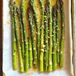 - 1 pound fresh asparagus, trimmed - 3 tablespoons olive oil - 4 cloves garlic, minced - Zest of 1 lemon - Juice of 1 lemon - 1 teaspoon sea salt - ½ teaspoon black pepper - ¼ teaspoon red pepper flakes (optional for heat) - 2 tablespoons grated Parmesan cheese (optional) When choosing asparagus, look for bright green stalks. They should feel firm and crisp. Avoid any that appear limp or have dark spots. For this recipe, the asparagus should be trimmed well. This means cutting off the tough ends, usually about 4-5 inches from the bottom. You want only the tender part. The flavorings are where this dish shines. Olive oil brings richness, while garlic adds a strong aroma. The lemon zest and juice offer a refreshing zing. This combination makes the dish bright and lively. For seasoning, sea salt enhances the natural flavors. Black pepper gives a mild heat, while red pepper flakes can add more spice if you like. If you want to elevate the dish, sprinkle grated Parmesan on top. It melts beautifully and adds a savory touch. For more details, check the Full Recipe. 1. Preheat the oven to 425°F (220°C). 2. Rinse and trim the asparagus. Start by washing it under cool water. Cut off the tough ends, leaving about 4-5 inches of the tender stalk. 3. Whisk together the lemon garlic mixture. In a bowl, combine 3 tablespoons of olive oil, 4 minced garlic cloves, the zest and juice of 1 lemon, 1 teaspoon of sea salt, ½ teaspoon of black pepper, and red pepper flakes if you like heat. 4. Toss the asparagus with the mixture. Add the trimmed asparagus to the bowl. Make sure every spear gets a nice coat of that zesty mixture. 5. Spread asparagus on a baking sheet. Lay the coated asparagus in a single layer on a parchment-lined baking sheet. 6. Roast asparagus for 12-15 minutes. Check for that vibrant color and tender-crisp texture. 7. Add cheese during the last minutes of roasting. If you're using Parmesan cheese, sprinkle it over the asparagus in the last 2 minutes for a melty finish. Enjoy your Lemon Garlic Roasted Asparagus as a delightful side dish with any meal. For the full recipe, check the details mentioned above. When choosing asparagus, look for bright green stalks. The tips should be firm and closed. If the stalks bend but do not break, they are fresh. Avoid any that are wilted or yellow. Fresh asparagus makes all the difference in taste and texture. Roasting asparagus is simple. Preheat your oven to 425°F (220°C). Spread the asparagus evenly on the baking sheet. Roast for about 12 to 15 minutes. Keep an eye on it. You want the asparagus to be vibrant in color and tender-crisp. You can test it by piercing a stalk with a fork. If it goes in easily, it's done! Lemon garlic roasted asparagus shines as a side dish. It pairs well with grilled meats like chicken or fish. You can also serve it alongside pasta or rice. For a great twist, add it to salads or grain bowls for a fresh crunch. {{image_2}} You can easily change the flavor of your Lemon Garlic Roasted Asparagus. Try adding herbs like thyme or rosemary. These herbs bring a fresh twist. Just sprinkle a little on before roasting. You’ll be amazed at how a small change makes a big difference. If you want to switch up the cheese, go for feta or goat cheese. These cheeses offer a creamy, tangy flavor that pairs well with asparagus. Sprinkle them on just before serving. This will add a rich taste that everyone will love. For a little kick, use cayenne pepper instead of red pepper flakes. A pinch can change the heat level. Adjust it to your taste. This small swap can turn your dish into a spicy delight. Store your Lemon Garlic Roasted Asparagus in an airtight container. It stays fresh in the fridge for up to 3 days. Just remember to cool it down before sealing. This way, it keeps its great flavor and texture. If you want to freeze it, first blanch the asparagus. Dunk it in boiling water for a minute, then transfer it to ice water. This helps preserve the color and taste. Once cooled, drain and pack it into freezer bags. You can store it for up to three months. Reheating is easy! The best way to bring back its crispness is to use the oven. Preheat it to 350°F (175°C) and heat the asparagus for about 10 minutes. This keeps it tasty and fresh. If you're in a hurry, you can use the microwave, but it might lose some crunch. For the full recipe, check out the recipe section. Fresh asparagus is recommended for optimal texture. Frozen asparagus may become mushy. Fresh spears hold their shape and crunch better. If you can find fresh, choose it for this dish. It should be vibrant in color and tender-crisp. Look for a bright green hue. You can test it by poking a spear with a fork. It should give a little but not be soft. Asparagus is rich in vitamins A, C, E, and K, as well as fiber and antioxidants. These nutrients support your immune system and promote healthy skin. Eating asparagus can aid digestion and boost overall health. Perfect alongside grilled chicken, fish, or as a topping for salads. This dish adds a fresh flavor to any meal. The lemon and garlic pair well with many proteins. Enjoy this asparagus as a vibrant side that enhances your dining experience. In this post, I shared a simple recipe for Lemon Garlic Roasted Asparagus. We covered choosing fresh asparagus, mixing key ingredients, and roasting techniques. I also discussed storage tips and serving ideas. Remember, fresh asparagus shines best with lemon and garlic. Try different herbs and cheeses to make it your own. Enjoy this healthy side dish and explore how it complements various meals. Happy cooking!