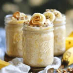 To make peanut butter banana overnight oats, you will need: - 1 cup rolled oats - 2 cups almond milk (or any milk of choice) - 2 ripe bananas, mashed - ¼ cup peanut butter (smooth or crunchy) - 2 tablespoons maple syrup (or honey) - ½ teaspoon vanilla extract - ½ teaspoon cinnamon - A pinch of salt - Optional toppings: sliced bananas, chopped nuts, chia seeds, or dark chocolate chips Using accurate measurements is key for great taste. Here’s how to measure: - Rolled oats: Use a dry measuring cup. - Almond milk: Use a liquid measuring cup for accuracy. - Bananas: Mash them well with a fork. - Peanut butter: For easier measuring, warm it slightly. - Maple syrup: Pour it carefully for the right amount. - Spices: Use measuring spoons for precision. Toppings can add fun and flavor. Here are some ideas: - Sliced bananas for extra sweetness. - Chopped nuts for crunch. - Chia seeds for added nutrition. - Dark chocolate chips for a treat. Feel free to mix and match these toppings to make your oats unique! Start by gathering your ingredients. You will need rolled oats, almond milk, and ripe bananas. In a large mixing bowl, combine 1 cup of rolled oats with 2 cups of almond milk. Then, mash 2 ripe bananas and add them to the bowl. Stir until everything mixes well. This base sets the stage for creamy, tasty oats. Next, it’s time to add the fun stuff! Add ¼ cup of peanut butter to the bowl. You can choose smooth or crunchy based on your taste. Then, pour in 2 tablespoons of maple syrup or honey for sweetness. Don’t forget the ½ teaspoon of vanilla extract and cinnamon. Lastly, add a pinch of salt. Mix all these ingredients until they blend perfectly. This step creates a rich, nutty flavor. Now, divide the mixture evenly into two mason jars or airtight containers. Make sure each jar has the same amount of oats and liquid. Seal the jars tightly and place them in the fridge. Let them soak overnight or at least for 4 hours. This soaking softens the oats and lets the flavors mingle. You’ll wake up to a delicious breakfast waiting for you! In the morning, take the jars out and give the oats a good stir. If the mixture is too thick, add a splash of almond milk. For toppings, get creative! You can add sliced bananas, chopped nuts, chia seeds, or dark chocolate chips. For a rustic look, serve the oats in the same jars. Drizzle some peanut butter on top and enjoy your tasty delight! You can make your overnight oats your own. Add your favorite nuts or seeds. Try sunflower seeds for a nut-free option. You can also mix in berries for a fruity twist. If you like it sweeter, add a bit more maple syrup or honey. You can even swap bananas for apples or peaches. The key is to play with flavors and textures until you find your favorite combo. For creamy oats, use rolled oats. They soak up liquid well and stay soft. Make sure to use enough liquid when mixing. I recommend two cups of almond milk for one cup of oats. If your oats seem too thick in the morning, just stir in a splash of milk. This helps achieve that perfect creamy texture. Want to amp up the taste? Consider adding a spoonful of cocoa powder for chocolatey goodness. A dash of nutmeg can add warmth and spice. For a fun crunch, sprinkle in some chopped nuts or seeds before serving. You can also add a drizzle of honey or maple syrup on top. Each extra touch makes your oats more exciting and delicious. Check out the Full Recipe for more ideas! {{image_2}} You can switch peanut butter for other nut butters. Almond butter adds a nice twist. Cashew butter offers a creamy texture. Sunflower seed butter is great for nut-free diets. Each nut butter brings unique flavors to the dish. Try them out to find your favorite! Use almond milk or coconut milk for a dairy-free option. Both milks keep the oats creamy and delicious. You can also use oat milk for a nut-free choice. Choose maple syrup instead of honey for a vegan-friendly sweetener. These swaps allow everyone to enjoy this tasty meal. You can mix in different fruits for more flavor. Berries like strawberries or blueberries add a fresh taste. Chopped apples or pears work well, too. For a tropical twist, add pineapple or mango. Experiment with spices like nutmeg or ginger for extra warmth. Each combination opens new taste experiences! Store your peanut butter banana overnight oats in airtight jars. Mason jars work well. You can also use plastic containers. Make sure they are sealed tightly to keep the oats fresh. Your oats can last in the fridge for up to five days. Keep an eye on the bananas. They may brown and change the taste. If you plan to eat them later, consider adding bananas just before serving. You can eat your overnight oats cold or warm them up. To reheat, place the oats in a bowl. Heat them in the microwave for about 30 seconds. Stir and check the temperature. If you want a creamier texture, add a splash of almond milk while heating. Some people love the cold, creamy taste right from the fridge. It's all about your preference! Yes, you can make these oats ahead of time. I often prepare them the night before. This way, they are ready to eat in the morning. You can store them in the fridge for up to five days. Each jar stays fresh and tasty. Just grab one when you need a quick breakfast! The oats need to soak for at least four hours. However, soaking them overnight gives the best results. This time allows the oats to absorb the liquid well. They become soft and creamy. The flavors also blend nicely during this time. If you want a change, try almond butter or cashew butter. Both give a nutty taste and work well. You can also use sunflower seed butter if you need a nut-free option. Each choice adds its own unique flavor to the oats. To lower the sugar, you can cut back on maple syrup. Use just one tablespoon instead of two. You can also skip the syrup and rely on ripe bananas for sweetness. They add natural sugar and great flavor without extra sweeteners. For the complete recipe, check out Nutty Banana Bliss Overnight Oats 🥜. This recipe lets you whip up a delicious breakfast with ease! To wrap up, we've covered key details about making peanut butter banana overnight oats. You learned the right ingredients, measurements, and optional toppings. I shared how to prepare, mix, and refrigerate your oats for the best flavor and texture. We discussed tips for customizing your dish, alternative ingredients, and storage methods. These oats can be a healthy start to your day. Enjoy experimenting with different flavors and toppings. With the right methods, you can create a perfect breakfast every time.