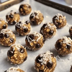 - 1 cup rolled oats - 1/2 cup natural peanut butter - 1/4 cup honey or maple syrup - 1/2 cup dark chocolate chips - 1/4 cup ground flaxseed - 1/2 teaspoon vanilla extract - 1/4 teaspoon sea salt - Optional: 1/4 cup shredded coconut The ingredients for Chocolate Peanut Butter Energy Bites are simple and nutritious. Rolled oats provide a great base, giving you energy. Natural peanut butter adds creaminess and healthy fats. Honey or maple syrup gives sweetness and helps bind the bites. Dark chocolate chips add a fun touch of flavor. Ground flaxseed boosts fiber and omega-3s. A splash of vanilla extract enhances taste, while sea salt balances the sweetness. If you want, add shredded coconut for extra texture and flavor. These energy bites are not just tasty; they are also good for you. They are energy-packed snacks that can fuel your day. The healthy fats from peanut butter keep you full longer. Fiber-rich ingredients like oats and flaxseed support digestion. This makes them a smart choice for both kids and adults. To make these bites, you will need a few tools. Mixing bowls help combine the ingredients well. Parchment paper makes cleaning up easier and prevents sticking. Measuring cups and spoons ensure you get the right amounts for each ingredient. With these tools, you’ll whip up these bites in no time. For the full recipe, check out the complete guide on how to make these delicious snacks. - Step 1: Combine dry ingredients Start by taking a large mixing bowl. Add the rolled oats, ground flaxseed, and sea salt. Mix these dry ingredients until they blend well. This step helps ensure an even flavor and texture. - Step 2: Mix wet ingredients In a different bowl, combine the natural peanut butter, honey or maple syrup, and vanilla extract. Stir until the mixture is smooth. This blend adds sweetness and creaminess to your bites. - Step 3: Combine both mixtures Pour the wet mixture into the bowl with the dry ingredients. Stir well until everything is coated. You want to see all the oats and flaxseed covered in that creamy goodness. - Size and shaping tips Using your hands, grab a small amount of the mixture. Form it into a ball about 1 inch in diameter. This size is perfect for snacking. Make sure they are all roughly the same size for even cooking. - Placement on baking sheet Place the shaped bites on a parchment-lined baking sheet. Make sure to leave some space between them. This helps them chill and firm up without sticking together. - Importance of refrigeration Chilling the bites is key. It helps them hold their shape and improves the texture. The cold makes them firmer and easier to eat. - Recommended chilling time Refrigerate the bites for at least 30 minutes. This time allows them to become perfectly set. After chilling, you can store them in an airtight container. They will stay fresh for up to a week. Enjoy your tasty snack! To make the best energy bites, focus on the mixture's consistency. It should be sticky but not too wet. If it's too dry, add a bit more peanut butter or honey. This helps the bites hold together. You can also adjust the sweetness to your taste. If you like them sweeter, add more honey or maple syrup. Start with a small amount and taste as you go. This way, you get the perfect flavor you want. One big mistake is overmixing the ingredients. When you overmix, the bites can become tough. Just mix until all the ingredients combine well. Another common error is not chilling them long enough. The bites need time to firm up in the fridge. Aim for at least 30 minutes. This step is key for a better texture. These energy bites are great on their own. You can also pair them with yogurt or fresh fruit. This adds a nice balance to your snack. For a fun twist, try them with a smoothie. They make a filling side that boosts energy. Enjoy them during a hike or as a midday treat. You can find the full recipe above if you want to make your own delicious energy bites! {{image_2}} You can change the flavor of your energy bites easily. Try using different nut butters. Almond or cashew butter tastes great too. You can even blend two nut butters for a special twist. Adding spices like cinnamon or nutmeg can also elevate the flavor. A pinch of sea salt can make the chocolate taste richer. If you want a vegan option, use maple syrup instead of honey. It works just as well and keeps the bites sweet. For a gluten-free choice, ensure you pick certified gluten-free oats. This way, everyone can enjoy these tasty snacks. Feel free to add your favorite mix-ins. Chopped nuts, seeds, or dried fruits add texture and flavor. Try cranberries, almonds, or pumpkin seeds. For a protein boost, mix in protein powder. It helps keep you full longer and adds extra nutrition. Store your chocolate peanut butter energy bites in an airtight container. This keeps them fresh and tasty. I recommend using a container that seals well. You can also use glass jars. Place them in the fridge after you make them. The cool air helps them stay firm. These bites last about a week in the fridge. If you want to keep them longer, freezing is a great option. They can stay good in the freezer for up to three months. Just make sure to wrap them well. Use plastic wrap or freezer bags to avoid freezer burn. Check for any signs of spoilage. If the bites smell bad or look dry, it’s time to toss them. You can also do a taste test. If they taste off or not sweet, it's best to discard them. Always trust your senses; they are your best guide. Chocolate peanut butter energy bites stay fresh for up to a week. Store them in an airtight container in the fridge. If you want them to last longer, you can freeze them. They freeze well for about three months. Just remember to thaw them in the fridge before snacking. Yes, you can make these bites nut-free! Use sun butter or soy nut butter instead of peanut butter. These options still give a creamy texture. You can also try using tahini, which is made from sesame seeds. Just keep in mind that the flavor will change a bit. You can mix in different flavors and textures! Try adding dried fruits like raisins or cranberries. Seeds like chia or pumpkin seeds work well too. For a fun twist, add spices like cinnamon or cocoa powder. You can even swap dark chocolate chips for white chocolate or butterscotch chips. Absolutely! Kids can help with many steps. They can mix the dry and wet ingredients together. Forming the bites into balls is fun for them too. Just be sure to supervise when using a knife or mixing bowl. It’s a great way to bond and teach them about cooking! In this blog post, we explored how to make delicious chocolate peanut butter energy bites. We covered essential ingredients, their nutritional benefits, and the tools you need. I shared easy steps for preparation and tips for perfecting your bites. Remember to customize them with different flavors and ingredients. Store them right for freshness. With these tips, you can create a healthy snack that fuels your day. Enjoy making and sharing these tasty bites with family and friends!
