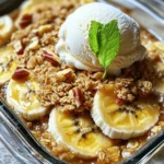 To make a tasty Bananas Foster Crisp, you need simple and fresh ingredients. Here’s what you will need: - 4 ripe bananas, sliced - 1 cup rolled oats - ½ cup brown sugar - ½ cup all-purpose flour - ½ teaspoon ground cinnamon - ¼ teaspoon nutmeg - ¼ cup unsalted butter, melted - ¼ cup chopped walnuts or pecans (optional) - 1 cup vanilla ice cream (for serving) - Fresh mint leaves for garnish (optional) Using ripe bananas is key. They should be soft and sweet for the best flavor. Rolled oats add a nice crunch to the dish. Brown sugar gives it a deep sweetness. The flour helps bind the topping. Ground cinnamon and nutmeg add warmth and spice. You can use unsalted butter to help the topping crisp up nicely. The optional nuts add texture and flavor. I love using walnuts, but pecans are great too. For serving, vanilla ice cream is a must. It melts into the warm crisp and makes it even more delicious. Fresh mint leaves can add a pop of color and a fresh taste. For the full recipe, you can check out the details to get started! 1. First, preheat your oven to 350°F (175°C). This step makes sure your dish bakes evenly. 2. Next, slice 4 ripe bananas and place them in a bowl. Add ¼ cup of brown sugar. Toss gently to coat the bananas. Set this mixture aside. 1. In another bowl, combine 1 cup of rolled oats, ½ cup of all-purpose flour, and the rest of the brown sugar (¼ cup). 2. Add ½ teaspoon of ground cinnamon and ¼ teaspoon of nutmeg to the mix. 3. Pour in ¼ cup of melted unsalted butter. If you like, add ¼ cup of chopped walnuts or pecans. Mix until combined. 4. Grease a baking dish. Spread the banana mixture evenly in the dish. 5. Sprinkle the oat topping over the bananas. Make sure it covers the bananas completely. 1. Place the dish in the oven. Bake for 25-30 minutes. Watch for a golden brown topping and bubbly bananas. 2. Once done, take it out and let it cool for a few minutes. This makes it easier to serve. 3. Serve warm with a scoop of vanilla ice cream on top. You can add fresh mint leaves for a nice touch. Enjoy making this delightful dessert! For the complete recipe, check out the Full Recipe. Choosing the right bananas is key for great flavor. You want ripe bananas for this dish. Look for bananas with yellow skin and some brown spots. This shows they are sweet and soft. Avoid green bananas; they are not sweet enough for baking. To get the perfect crunch on your oat topping, use rolled oats. Mix them with flour, brown sugar, and melted butter. This combination gives a nice, crispy layer. You can add nuts for more texture. Walnuts or pecans work well. If you want a twist, try adding coconut flakes or seeds. Serve your Bananas Foster Crisp warm. A scoop of vanilla ice cream on top adds creaminess. You can also garnish with fresh mint leaves for color. For a fun twist, drizzle some caramel sauce over the top. Arrange it in a nice bowl to make it look special. For the full recipe, check out the detailed steps above! {{image_2}} To make Bananas Foster Crisp your own, try using different nuts or seeds. You can replace walnuts or pecans with almonds or sunflower seeds. Each will add a new crunch and flavor. If you're looking for healthier options, swap out the brown sugar. You could use coconut sugar or maple syrup. These swaps keep the dessert sweet while adding unique flavors. Want to amp up the taste? Add chocolate chips or dried fruits like raisins or cranberries to the oat topping. This twist adds richness and sweetness. You can also infuse spices for extra flavor. Try a hint of ginger or a dash of vanilla extract. Both will give your dish a warm and inviting aroma. For a gluten-free version, use almond flour or gluten-free oats instead of regular flour. This keeps the crunch and flavor intact. Ensure all your ingredients are certified gluten-free. This way, you can enjoy your dessert without worry. You won't lose any taste with these changes! To keep Bananas Foster Crisp fresh, place it in an airtight container. Store it in the fridge. This way, it stays safe and tasty. You can keep it for up to three days. After that, the texture may change, and the flavors fade. When you reheat, use the oven for the best results. Set the oven to 350°F (175°C). Put the crisp in a baking dish, cover it with foil, and heat for about 15 minutes. This keeps the topping crunchy and the bananas soft. You can freeze Bananas Foster Crisp, but it’s best to eat it fresh. If you freeze it, wrap it tightly and use it within a month. You can prepare Bananas Foster Crisp a day in advance. Store the layered dish in the fridge before baking. When you are ready, bake it as per the instructions. This helps save time when you want to serve it. For fresh taste, serve it warm with ice cream right after baking. Bananas Foster Crisp is a warm dessert made with bananas and a crunchy topping. It blends sweet, soft bananas with a crispy oat layer. This dish comes from New Orleans, where it gained fame. The classic Bananas Foster features flambéed bananas. In this twist, we bake ripe bananas with oats. The result is a cozy treat perfect for sharing. Yes, you can swap bananas for other fruits. Apples and peaches work well in this recipe. Berries like blueberries or strawberries add a fresh twist. Just make sure the fruit is ripe and sweet. This way, you keep the flavor bright and enjoyable for everyone. To make a vegan version, replace the butter with coconut oil or vegan butter. Use maple syrup instead of brown sugar for sweetness. You can also skip the ice cream or use a plant-based option. These swaps keep the dish tasty while meeting vegan needs. Enjoy every bite without missing out! In this post, we explored the delicious recipe for Bananas Foster Crisp. We covered ingredients, step-by-step instructions, and helpful tips. You learned how to choose ripe bananas and perfect the oat topping. We also shared variations and storage tips to enhance your experience. Bananas Foster Crisp is not only tasty but also versatile. You can adapt it to fit your needs. Enjoy every bite and make it your own!