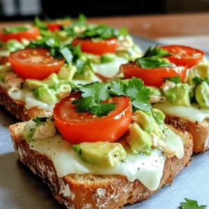 This Chicken Avocado Melt is a tasty dish that combines chicken and avocado. It’s easy to make and full of flavor. You can enjoy it for lunch or dinner. Let’s look at what you need to make this delicious meal. Here’s what you will need to make the Chicken Avocado Melt: - 2 boneless, skinless chicken breasts - 1 ripe avocado, peeled and mashed - 1 cup shredded mozzarella cheese - ½ cup cherry tomatoes, halved - ¼ cup red onion, finely chopped - 2 tablespoons olive oil - 1 tablespoon lime juice - Salt and pepper to taste - 4 slices of whole-grain bread - Fresh cilantro for garnish (optional) These ingredients come together to create a dish that is rich and satisfying. If you can’t find some of these ingredients, don’t worry! Here are some easy swaps: - Chicken Breasts: You can use grilled chicken thighs or rotisserie chicken. - Avocado: If you don’t have avocado, try hummus for a different taste. - Mozzarella Cheese: Cheddar or pepper jack cheese can add a fun twist. - Whole-Grain Bread: Use any bread you enjoy, like sourdough or rye. - Cilantro: Parsley or green onions can work well too. Feel free to get creative! Substitutions can help you make this recipe your own. To make your Chicken Avocado Melt, start by gathering your ingredients. You need: - 2 boneless, skinless chicken breasts - 1 ripe avocado, peeled and mashed - 1 cup shredded mozzarella cheese - ½ cup cherry tomatoes, halved - ¼ cup red onion, finely chopped - 2 tablespoons olive oil - 1 tablespoon lime juice - Salt and pepper to taste - 4 slices of whole-grain bread - Fresh cilantro for garnish (optional) First, preheat your oven to 375°F (190°C). Next, heat olive oil in a skillet over medium heat. Season the chicken breasts with salt and pepper. Cook the chicken for 6-7 minutes on each side. Make sure it's cooked through. After cooking, let the chicken rest for a few minutes. Then, slice it into thin strips. Now, it's time to mix up the avocado spread. In a bowl, combine the mashed avocado, lime juice, and chopped red onion. Add a pinch of salt and mix well. Take a baking sheet and lay out the slices of whole-grain bread. Spread a generous amount of the avocado mixture on each slice. Next, add slices of chicken on top. Follow this with halved cherry tomatoes. Finally, sprinkle shredded mozzarella cheese over everything. Place the baking sheet in the preheated oven. Bake for about 10-12 minutes. Look for the cheese to melt and bubble. Once done, remove from the oven and let it cool slightly. If you like, garnish with fresh cilantro. Your Chicken Avocado Melt is now ready to enjoy! Serve it warm on a plate. This dish pairs well with a fresh salad or crispy chips for crunch. You can also add a side of salsa for extra flavor. This meal is perfect for lunch, dinner, or a cozy snack. If you want to try this recipe, check the Full Recipe for all the details. To cook chicken well, start with fresh meat. I recommend using boneless, skinless chicken breasts. Season them simply with salt and pepper. Heat your skillet to medium. Add olive oil and wait until it shimmers. Cook each side for 6-7 minutes. The chicken should be golden brown and cooked through. Use a meat thermometer to check that it reaches 165°F (74°C). Let it rest for a few minutes before slicing. This helps keep it juicy. To create a great avocado mix, choose ripe avocados. They should be slightly soft when you press them. Peel and mash them in a bowl. Add lime juice right away to prevent browning. Stir in finely chopped red onion and a pinch of salt. Mix it until smooth but still chunky. This mix adds creaminess to your Chicken Avocado Melt. You can also add diced tomatoes for extra flavor. For a perfect cheese melt, use shredded mozzarella. It melts well and gives a nice stretch. Spread the cheese evenly over the chicken and avocado mix. Bake the Chicken Avocado Melt in a preheated oven at 375°F (190°C). Bake it for about 10-12 minutes. Keep an eye on it until the cheese is bubbly and golden. You can broil it for a minute at the end for a nice finish. Enjoy this tasty treat! You can find the Full Recipe above for all the details. {{image_2}} You can switch up the chicken for turkey or even ham. Both meats add a nice, savory twist. If you want something lighter, try using grilled shrimp. The seafood pairs well with avocado. For a touch of sweetness, add thin slices of pear or apple. These fruits bring a new flavor and texture. To make a vegetarian version, skip the chicken. Use grilled zucchini or eggplant instead. Both veggies have great texture and flavor when cooked. You can also try chickpeas; they add protein and a hearty bite. For cheese lovers, use a plant-based cheese to keep it vegan. For more flavor, try different herbs and spices. Garlic powder adds a warm kick, and smoked paprika gives a nice depth. You can also mix in fresh herbs like basil or cilantro. If you love heat, sprinkle red pepper flakes on top before baking. This adds a fun, spicy surprise to every bite. To keep your Chicken Avocado Melt fresh, store it in an airtight container. Let the dish cool before sealing. This helps maintain its taste. Place it in the fridge. It will stay good for up to three days. If you use a glass container, it’s even better. This keeps the food safe and tasty. When you're ready to enjoy leftovers, reheat it in the oven. Set the oven to 350°F (175°C). Place the melt on a baking sheet. Heat for about 10 minutes. This warms it evenly and keeps the cheese melty. You can also use a microwave. Heat on high for about 1-2 minutes. Just be careful not to overheat, or the bread will get soggy. If you want to save some for later, freezing works too. Wrap each melt in plastic wrap, then put it in a freezer bag. This keeps ice crystals away. You can freeze them for up to two months. When you’re ready to eat, thaw it in the fridge overnight. Then, reheat it as mentioned before. Enjoy your Chicken Avocado Melt even after weeks! The Chicken Avocado Melt will stay fresh for about three days. Store it in an airtight container in the fridge. The bread may get a bit soft, but the filling tastes great. Yes, you can prepare parts of this recipe ahead of time. Cook the chicken and make the avocado mixture a day before. Just assemble the melts when you are ready to bake. This way, you save time and still enjoy a fresh meal. You can pair the Chicken Avocado Melt with a side salad or some crispy veggies. Chips or sweet potato fries work well too. If you like, add some fresh fruit for a sweeter touch. For the full recipe, check out the Chicken Avocado Melt section above. This blog covers all you need for a tasty Chicken Avocado Melt. We explored key ingredients, listed necessary items, and suggested substitutes. I shared step-by-step cooking instructions and serving ideas. You learned best practices and cheese melting tips for success. We also discussed variations and smart storage methods to keep your meal fresh. Finally, I answered common questions to help you feel prepared. Enjoy making this dish, and let your creativity shine with each bite!
