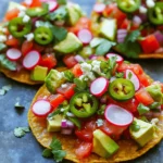- 1 cup pickled jalapeños, diced - 1 cup diced tomatoes - ½ cup red onion, finely chopped - ½ cup fresh cilantro, chopped - 1 avocado, diced - 1 tablespoon lime juice - Salt to taste - 8 tostada shells - 1 cup crumbled queso fresco (or your preferred cheese) - Sliced radishes for garnish Gather these fresh ingredients to make the best Pickle De Gallo Tostadas. Each ingredient plays a key role in creating a burst of flavor. The pickled jalapeños add heat, while the tomatoes bring sweetness. Red onion adds crunch, and cilantro brings a fresh taste. Use ripe avocados for creaminess and a squeeze of lime for a zesty kick. Don't forget the salt to enhance all the flavors. Choose your favorite cheese to sprinkle on top. Then, get some crispy tostada shells to hold everything together. These simple ingredients make a vibrant treat. You can find the full recipe in the earlier section of this article. Enjoy making these tasty tostadas! To start, gather your ingredients. In a medium bowl, combine: - 1 cup pickled jalapeños, diced - 1 cup diced tomatoes - ½ cup red onion, finely chopped - ½ cup fresh cilantro, chopped Next, drizzle in 1 tablespoon of lime juice. Add salt to taste. Gently toss everything together until well mixed. This mixture is fresh and bright. It brings a nice kick to your tostadas. Now, let's get those tostada shells ready. Preheat your oven to 350°F (175°C). Spread the tostada shells on a baking sheet. Bake them for 5 to 7 minutes. You want them to be crispy but not burnt. Keep an eye on them as they bake. Once the shells are crispy, take them out of the oven. Let them cool slightly. Then, it's time to build your tostadas. Top each shell with a generous spoonful of the pickle de gallo mixture. Next, add diced avocado on top for creaminess. Finally, sprinkle crumbled queso fresco over each tostada for a salty bite. For a nice touch, garnish with sliced radishes. These add color and crunch. Enjoy your fresh and flavorful Pickle De Gallo Tostadas! For the complete steps, check the Full Recipe. - Use fresh ingredients for the best flavor. Fresh tomatoes, cilantro, and jalapeños make a big difference. They add bright flavors and vibrant colors to your tostadas. - Adjust lime and salt for personal taste. Taste your pickle de gallo mix as you go. If you like it tangier, add more lime juice. If it needs salt, sprinkle a bit more until it tastes just right. - Baking vs. frying: which method to choose? Baking is healthier and easier. I like to bake my tostada shells at 350°F for 5-7 minutes. This gives them a nice crunch without the mess of frying. - How to store tostada shells before serving. Keep your tostada shells in an airtight container. This keeps them crisp until you are ready to serve. Avoid stacking them to prevent them from getting soft. {{image_2}} You can play with different types of peppers to change the heat level. Try serrano or habanero for a spicier kick. Each pepper brings its own flavor and heat, so have fun experimenting. You can also switch up the cheese. Crumbled feta or shredded cheddar can add a unique twist. Don’t be afraid to mix flavors! If you want a vegan option, you can skip the cheese or use a plant-based cheese. There are great vegan cheeses that melt well and taste good. For those needing gluten-free options, look for tostada shells made from corn. They are crunchy and perfect for this dish. These tostadas make great snacks or appetizers. You can serve them at parties or family gatherings. For a fun twist, pair them with dips like guacamole or salsas. They can add extra flavor and texture to your meal. Consider stacking some tostadas for a beautiful display on your table. Enjoy the fresh and vibrant flavors of your Pickle De Gallo Tostadas! Check the Full Recipe for more ideas. Store leftover pickle de gallo mixture in a sealed container. Keep it in the fridge. It will stay fresh for about 3 days. The flavors will blend together, which can make it even tastier. If you want to keep it longer, freeze it. Just remember to thaw it in the fridge before using. For tostada shells, store them in a cool, dry place. Use a zip-top bag or an airtight container. They can last for about 2 weeks. If you see any signs of moisture, toss them out. Moisture can make the shells soggy. To reheat tostadas, you want them to stay crispy. The best way is to use the oven. Preheat your oven to 350°F (175°C). Place the tostadas on a baking sheet. Heat them for about 5 minutes. This will help them regain their crunch. Avoid using the microwave, as it can make them soft and chewy. - Pickled jalapeños: Last for 1-2 months in the fridge. - Diced tomatoes: Keep for 3-5 days in the fridge. - Red onion: Can stay fresh for about 1-2 weeks. - Fresh cilantro: Lasts for up to 1 week. - Avocado: Best used within 1-2 days once cut. - Lime juice: Fresh juice lasts about 1 week; bottled juice can last longer. - Salt: Indefinite shelf life if kept dry. - Tostada shells: Can be stored for 2 weeks. - Queso fresco: Best used within 1 week once opened. - Sliced radishes: Keep for about 5 days in the fridge. Pickle de gallo is a fresh, zesty salsa made with pickled jalapeños, tomatoes, onions, and cilantro. You mix these ingredients together, adding lime juice and salt for flavor. This dish brings a nice crunch and bright taste to any meal. It is great on its own or as a topping for tostadas. Yes, you can prep some parts in advance. Make the pickle de gallo mixture a day before and store it in the fridge. Just keep the tostada shells separate until you are ready to serve. This way, they stay crispy. Assemble your tostadas just before eating for the best taste. You can top your tostadas with many things. Here are some great options: - Sliced avocado for creaminess - Crumbled queso fresco or your favorite cheese - Fresh cilantro for extra flavor - Sliced radishes for crunch - A drizzle of sour cream for tanginess - Chopped green onions for freshness Mix and match to find your favorite combinations! Pickle De Gallo Tostadas are easy and fun to make. We covered the ingredients and how to prepare them. You learned ways to make your tostadas extra crispy and how to store leftovers. Try different peppers or cheeses for unique flavors. Enjoy this tasty snack with friends or family! With these tips, you can create the perfect dish every time. Great food brings people together. Enjoy your cooking adventure!