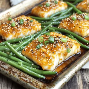 - 2 cod fillets (about 6 oz each) - 8 oz green beans, trimmed - 2 cloves garlic, minced - 1 teaspoon fresh ginger, grated - 2 tablespoons white miso paste - 2 tablespoons maple syrup - 1 tablespoon soy sauce (low-sodium) - 1 tablespoon rice vinegar - 1 tablespoon olive oil - Salt and pepper to taste - Sesame seeds - Sliced green onions Using fresh ingredients makes a big difference. The cod fillets should be firm and bright. The green beans need to be crisp and vibrant. Fresh garlic and ginger add a punch of flavor. You’ll get the best taste from good-quality miso paste and pure maple syrup. In your pantry, keep low-sodium soy sauce and rice vinegar handy. These add depth to the dish. Olive oil helps to toss the green beans and adds richness. Salt and pepper round out the flavor nicely. For garnishes, sesame seeds add a nice crunch. Sliced green onions give freshness and color. You can serve the meal right from the pan for a rustic touch. Enjoy the bright colors and rich flavors! First, set your oven to 400°F (200°C). This temperature helps cook the cod and green beans evenly. While the oven heats, get your tools ready. Grab a large sheet pan, a small bowl, and a whisk. In a small bowl, mix together these ingredients carefully: - 2 tablespoons white miso paste - 2 tablespoons maple syrup - 1 tablespoon low-sodium soy sauce - 1 tablespoon rice vinegar - 2 cloves garlic, minced - 1 teaspoon fresh ginger, grated Whisk them until smooth. This marinade gives the cod a sweet and savory flavor. Place the cod fillets in a shallow dish. Pour the miso marinade over the cod. Cover the dish and put it in the fridge. Let it marinate for at least 15 minutes, or up to 1 hour if you have more time. While the cod marinates, prepare the green beans. Trim the ends of the beans. On the sheet pan, toss the trimmed beans with 1 tablespoon olive oil. Add salt and pepper to taste. Spread the green beans evenly on one half of the pan. After marinating, take the cod out of the fridge. Remove it from the marinade, but save the extra marinade. Place the cod on the other half of the sheet pan. Now, it's time to bake! Place the sheet pan in the oven. Bake for 15-20 minutes. The cod should be opaque and flaky. The green beans will be tender-crisp. Halfway through cooking, brush the saved marinade over the cod for extra flavor. Once done, take the pan out of the oven. For a nice touch, sprinkle sesame seeds and sliced green onions on top. This makes the dish look fresh and inviting. To get the best texture for cod, start with fresh fillets. Fresh fish has a nice firmness. When marinating, allow the cod to soak for at least 15 minutes. This time lets the flavors seep in. If you have more time, let it marinate for up to an hour. This longer soak makes the fish even tastier. Once baked, the cod should flake easily. You’ll know it’s done when it turns opaque. Miso is a star in this dish. The white miso paste gives a rich, savory taste. Mixing it with maple syrup adds sweetness. The soy sauce and rice vinegar balance the flavors nicely. For more depth, add minced garlic and grated ginger. They bring warmth and spice to the marinade. Remember to brush the reserved marinade on the cod halfway through baking. This step boosts the flavor even more. Ovens can vary in heat. If your oven runs hot, check the cod at 15 minutes. If it’s cooler, you might need the full 20 minutes. Always look for the cod to be opaque and flaky. Use a fork to test the texture. The green beans should be tender-crisp. If they need more time, you can leave them in a bit longer. Just keep an eye on the cod to avoid overcooking it. {{image_2}} You can use many vegetables with this dish. Instead of green beans, try broccoli, asparagus, or bell peppers. Each veggie adds its own flavor and texture. Just make sure to cut them to a similar size for even cooking. Toss them in olive oil, salt, and pepper just like the green beans. This way, they will cook perfectly with the cod. Cod is a great choice, but you can switch it up. Salmon, tilapia, or even shrimp work well. Each protein brings a unique taste. If you choose salmon, keep the cooking time the same. For shrimp, reduce the time to about 10-12 minutes. This way, everything stays tender and full of flavor. Get creative with the marinade! You can try a teriyaki sauce instead of the miso mix. It gives a sweet and savory taste. For a spicy kick, add some sriracha to the mix. You can also use a lemon-garlic marinade for a fresh twist. Mixing and matching flavors can keep your meals exciting and new. To store your leftover sheet pan miso maple cod and green beans, first, cool them down. Place the food in a shallow container. This helps it cool faster. Cover the container with a tight lid or plastic wrap. Store it in the fridge for up to three days. Make sure to keep the cod and green beans together. This keeps the flavors intact. If you want to save the dish for later, you can freeze it. First, let the cod and green beans cool completely. Then, place them in an airtight container or a freezer bag. Remove excess air to prevent freezer burn. You can freeze the dish for up to three months. When you’re ready to eat, just thaw it in the fridge overnight. To reheat, use the oven or a microwave. For the oven, preheat it to 350°F (175°C). Place the cod and green beans on a baking sheet. Heat for about 10-15 minutes, or until warm. If using a microwave, place the food in a microwave-safe dish. Heat in short bursts, about 1-2 minutes at a time. This helps avoid overheating. Always check that the cod is hot all the way through before serving. Yes, you can prepare this dish ahead of time. You can marinate the cod and trim the green beans a few hours before cooking. Just keep the marinated cod in the fridge until you are ready to bake. This helps the flavors soak in more! If you want to swap out cod, use other firm fish. Salmon, halibut, or tilapia work well. These fish have similar textures and will still taste great with the miso maple sauce. To make this dish gluten-free, simply replace soy sauce with tamari. Tamari is a gluten-free soy sauce alternative. All other ingredients in this recipe are naturally gluten-free, so you’re good to go! This blog post covered the key ingredients and step-by-step process for making a tasty cod dish. I shared helpful tips to perfect the texture and flavor while exploring variations using different proteins and veggies. Proper storage methods keep your leftovers fresh. Always remember, you can easily make this dish gluten-free or prep it ahead. Enjoy cooking and experimenting with your meals!