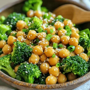 To make this dish, gather the following ingredients: - 1 can (15 oz) chickpeas, drained and rinsed - 2 cups broccoli florets - 2 tablespoons sesame oil - 1 tablespoon fresh ginger, grated - 3 cloves garlic, minced - 1/4 cup soy sauce or tamari for gluten-free - 2 tablespoons honey or maple syrup - 1 tablespoon rice vinegar - 1 tablespoon cornstarch - 2 tablespoons sesame seeds - 2 green onions, chopped - Salt and pepper to taste These ingredients create a tasty and vibrant dish that is both healthy and satisfying. If you want to boost the taste, consider adding: - A pinch of red pepper flakes for heat - Fresh cilantro for a fresh touch - Lime juice for a zesty finish These extras can add a punch and make the dish more exciting. You can easily swap ingredients if needed: - Use canned lentils instead of chickpeas for a different texture. - Swap soy sauce with coconut aminos for a soy-free option. - Maple syrup can replace honey for a vegan choice. These substitutions help you customize the recipe to your taste and dietary needs. Start by heating 1 tablespoon of sesame oil in a large skillet over medium heat. Add the drained and rinsed chickpeas to the skillet. Sauté them for about 5 minutes. You want them to be slightly crispy. Season with a pinch of salt and pepper to taste. Once done, remove the chickpeas from the skillet and set them aside. This step adds a nice texture to the dish. In the same skillet, add the remaining tablespoon of sesame oil. Once hot, toss in the broccoli florets. Sauté for 3 to 4 minutes. The broccoli should turn a vibrant green and become slightly tender. Season it with a bit of salt and pepper. This ensures the broccoli stays crunchy and fresh. Now, grab a small bowl to make the sticky sesame sauce. Whisk together soy sauce, honey or maple syrup, rice vinegar, cornstarch, grated ginger, and minced garlic. Mix until smooth. This sauce brings all the flavors together and coats the chickpeas and broccoli perfectly. Return the crispy chickpeas to the skillet with the broccoli. Pour the prepared sauce over the top. Stir gently to coat everything evenly. Cook for an additional 2 to 3 minutes. This helps the sauce thicken and ensures everything is heated through. Once the dish is ready, sprinkle sesame seeds over the top. Give it a gentle stir to mix them in. Remove the skillet from the heat and garnish with chopped green onions. This adds a nice pop of color and flavor. Serve the dish warm for the best taste. Enjoy your delicious sticky sesame chickpeas and broccoli! To make crispy chickpeas, start with drained and rinsed canned chickpeas. Dry them well with a towel. Heat sesame oil in a skillet over medium heat. Add chickpeas and stir them often. Cook for about 5 minutes until they are golden and crisp. Season with salt and pepper for flavor. If you want extra crunch, try roasting them in the oven. Spread them on a baking sheet and bake at 400°F for 20 minutes. For bright, tender broccoli, use fresh florets. Start by washing them under cool water and cutting them into uniform pieces. This ensures even cooking. Sauté the broccoli in sesame oil for 3 to 4 minutes. You want them to stay bright green and slightly firm. Avoid overcooking to keep the nutrients intact. A pinch of salt helps enhance the natural flavor. To change the sauce thickness, mix cornstarch with a bit of water before adding it. This helps avoid lumps. If you like a sweeter sauce, add more honey or maple syrup. For a tangy taste, increase the rice vinegar. Taste your sauce as you mix. Adjust it until you find the perfect balance for your dish. This personal touch makes your meal special. {{image_2}} You can easily add more veggies to this dish. Try bell peppers, carrots, or snap peas. These will add color and crunch. You can sauté them with the broccoli. Just make sure they are tender but still crisp. This way, you keep all the great flavors. You can also use frozen vegetables if you’re short on time. Just add them to the skillet while cooking the broccoli. If you want more protein, tofu or tempeh works great. For tofu, press it to remove extra water. Cut it into small cubes and sauté it until golden. Add it to the chickpeas and broccoli when you mix everything. For tempeh, slice it thin and steam it for a few minutes. Then, sauté it until it’s brown. Both options will soak up the sauce well and add a nice texture. To make this dish gluten-free, just use tamari instead of soy sauce. It has a similar flavor without gluten. For vegan options, replace honey with maple syrup. This will keep the dish sweet and delicious. Make these simple swaps, and you can enjoy this dish with everyone. It’s a tasty and healthy meal that fits many diets! To keep your sticky sesame chickpeas and broccoli fresh, let them cool first. Use an airtight container for storage. Place the leftovers in the fridge. They will stay good for about three days. If you want to keep them longer, consider freezing them. To reheat, use a skillet on medium heat. Add a splash of water or oil to help them heat evenly. Stir often to avoid sticking. You can also use the microwave. Place the meal in a microwave-safe dish and cover it. Heat for one to two minutes, stirring halfway through. For freezing, pack the chickpeas and broccoli in a freezer-safe bag. Remove as much air as possible before sealing. They will last for about three months in the freezer. When ready to eat, thaw them in the fridge overnight. Reheat in a skillet or microwave as mentioned above. The best way to cook chickpeas is to use canned ones. They save time and are very easy to use. First, drain and rinse the chickpeas. This removes extra salt and makes them taste fresh. Sauté them in sesame oil until they get crispy. This adds a great texture and flavor. Yes, you can make this dish ahead of time. You can cook the chickpeas and broccoli and mix them with the sauce. Store everything in the fridge for up to three days. When you're ready to eat, just reheat it in a skillet. This keeps the flavors fresh and tasty. Sticky sesame chickpeas and broccoli pair well with many dishes. You can serve them over rice or quinoa for a hearty meal. Noodles are another great option. Adding a side of crispy tofu or a fresh salad can also make a nice meal. Adjusting the recipe is simple. For gluten-free options, use tamari instead of soy sauce. If you're vegan, swap honey for maple syrup. You can also add more veggies to fit your diet. Bell peppers or carrots work well and add more color. This blog post covered the key ingredients and steps for making sticky sesame chickpeas and broccoli. You learned about required and optional ingredients, cooking methods, and how to store leftovers. Variations gave you creative options, while tips ensured the best results. I hope this dish becomes a new favorite in your kitchen. Enjoy the flavors and have fun adapting it to your taste!
