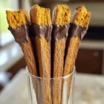 - 2 cups all-purpose flour - 1 teaspoon baking powder - ½ teaspoon baking soda - 1 teaspoon ground cinnamon - ½ teaspoon ground ginger - ¼ teaspoon ground nutmeg - ¼ teaspoon ground cloves - ½ teaspoon salt - ½ cup unsalted butter, softened - ¾ cup granulated sugar - 1 large egg - 1 teaspoon vanilla extract - ½ cup canned pumpkin puree - ¾ cup chopped pecans or walnuts - 1 cup dark chocolate chips for dipping The key to great chocolate dipped pumpkin spice biscotti is the ingredients. Start with the dry ingredients. Flour is the base. Baking powder and baking soda help the biscotti rise. Spices like cinnamon, ginger, nutmeg, and cloves give it that warm, fall flavor. Don’t forget the salt; it balances the sweet. For the wet ingredients, soften your butter first. This makes it easy to cream with sugar. The sugar adds sweetness and helps create that light texture. Use one large egg for binding. Vanilla extract adds depth, while pumpkin puree gives moisture and flavor. If you want texture, consider adding chopped nuts. Pecans or walnuts work great. Finally, for that chocolatey finish, have dark chocolate chips ready for dipping. This combination creates a cozy, delicious treat perfect for any time. 1. Preheat the oven to 350°F (175°C). 2. In a medium bowl, whisk together: - 2 cups all-purpose flour - 1 teaspoon baking powder - ½ teaspoon baking soda - 1 teaspoon ground cinnamon - ½ teaspoon ground ginger - ¼ teaspoon ground nutmeg - ¼ teaspoon ground cloves - ½ teaspoon salt Set this aside. 3. In a large bowl, cream together: - ½ cup unsalted butter, softened - ¾ cup granulated sugar Mix until light and fluffy. 1. Beat in: - 1 large egg - 1 teaspoon vanilla extract - ½ cup canned pumpkin puree Mix until everything is combined. 2. Gradually mix in the dry ingredients. If you like, fold in: - ¾ cup chopped pecans or walnuts This adds a nice crunch! 1. Divide the dough into two. Form each half into a log, about 12 inches long and 2 inches wide. 2. Place the logs on a parchment-lined baking sheet. 3. Bake for 25-30 minutes, or until they are lightly browned and firm. 4. Let the logs cool for 10-15 minutes. 5. Once cool, slice them diagonally into ½ inch thick pieces. 6. Place the slices cut side down back onto the baking sheet. 7. Bake again for 15-20 minutes, flipping halfway. This step makes them crisp! 8. Let them cool completely on a wire rack. 9. In a microwave-safe bowl, melt: - 1 cup dark chocolate chips Do this in intervals of 30 seconds, stirring in between. 10. Dip the ends of each biscotti in the melted chocolate. Let any excess chocolate drip off. 11. Place them on parchment paper to set. To get the best texture in your biscotti, avoid overmixing. Mix the dough just until it comes together. Too much mixing makes them tough. You want a soft, slightly sticky dough. If it feels dry, add a touch more pumpkin puree. This keeps the biscotti moist and tasty. Melting chocolate can be simple. Use a microwave-safe bowl. Heat chocolate chips in 30-second bursts. Stir in between until smooth. This prevents burning. For dipping, hold the biscotti by one end. Dip it into the melted chocolate. Let the excess chocolate drip off. Place it on parchment paper to set. Serve your biscotti in a tall glass for a fun look. You can also arrange them on a nice platter. Dust with powdered sugar for a fancy touch. To store, keep them in an airtight container. This keeps them fresh and crunchy. Enjoy your treats with coffee or tea! {{image_2}} You can change the taste of your biscotti by adding different spices. Cardamom gives a warm flavor. Allspice adds a nice kick. You can also skip the nuts if you want a smoother bite. If you like crunch, pecans or walnuts work great. Just chop them up and mix them in. If you want a twist, try white chocolate instead of dark chocolate. White chocolate offers a sweet contrast to the pumpkin spices. You can even use flavored chocolate. Peppermint chocolate gives a fresh taste. Almond chocolate adds a nutty layer of flavor. Just melt and dip your biscotti like you would with dark chocolate. Pair your chocolate dipped pumpkin spice biscotti with warm drinks. A cup of coffee or tea works perfectly. Hot cocoa also makes a cozy match. You can create a themed platter with other treats. Mini muffins or cookies can add variety. Just arrange them on a nice plate for a fun dessert spread. To keep your chocolate dipped pumpkin spice biscotti fresh, store them in a cool, dry place. Use an airtight container to prevent moisture. A glass jar or a plastic container works well. Place a piece of parchment paper between layers to avoid sticking. This will keep the biscotti crisp for longer. Freezing biscotti is a great way to enjoy them later. First, let them cool completely. Then, wrap each piece in plastic wrap. Place the wrapped biscotti in a freezer bag. Remove as much air as possible before sealing. To thaw, simply take them out and let them sit at room temperature for about 30 minutes. For best quality, enjoy them within three months. At room temperature, your biscotti will stay fresh for about two weeks. Keep an eye out for signs of spoilage. If they become soft or lose their crunch, it’s time to toss them. If you see mold or an off smell, do not eat them. Proper storage helps extend their life and keeps them tasty. To make your biscotti less hard, you can bake it for a shorter time. Try reducing the second bake to 10-15 minutes. You can also add more pumpkin puree for moisture. This change may help keep the biscotti softer. Yes, you can use pumpkin pie spice. Just replace the individual spices with 2 teaspoons of pumpkin pie spice. It will add a great flavor to your biscotti. This option is a time-saver and works well. The best way to dip biscotti in chocolate is to melt the chocolate until smooth. Use a microwave or a double boiler. Dip one end of the biscotti into the chocolate, letting excess chocolate drip off. Place it on parchment paper to set. Homemade biscotti stays fresh for about two weeks when stored in an airtight container. Keep it in a cool, dry place. For longer storage, you can freeze it for up to three months. Just let it thaw at room temperature. Yes, you can use a dairy-free alternative like coconut oil or vegan butter. This swap works well and keeps the flavor intact. Just ensure the alternative is softened for easy mixing. You learned how to make delicious biscotti using simple, tasty ingredients. We started with the dry and wet ingredients, mixed them with care, and baked them to perfection. You can even change flavors and pair your biscotti with drinks or other sweets. Remember, storing your biscotti correctly keeps them fresh longer. Enjoy every bite, and get creative with your own twists on this treat!