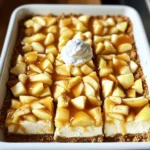 - 1 ½ cups graham cracker crumbs - ½ cup unsalted butter, melted - 1 cup granulated sugar, divided - 1 (8 oz) package cream cheese, softened - 2 large eggs - 1 teaspoon vanilla extract - 2 cups peeled and diced apples (e.g., Granny Smith or Honeycrisp) - 1 teaspoon cinnamon - 1 cup caramel sauce (store-bought or homemade) - Optional: whipped cream and additional caramel for topping The key ingredients for these bars create a rich and tasty treat. The graham cracker crumbs form a crunchy crust. The unsalted butter helps bind the crumbs together. Using granulated sugar sweetens both the crust and the filling. Cream cheese gives the bars a creamy texture. Eggs help set the filling when baking. Vanilla extract adds a warm flavor that blends well. Apples bring a fresh taste and slight crunch. I recommend using tart apples, like Granny Smith or Honeycrisp, for a nice balance. Cinnamon adds warmth and spice that pairs perfectly with apples. Caramel sauce drizzled on top adds sweetness and richness. If you want to take it up a notch, whipped cream and extra caramel make great toppings. - Mixing bowls - Baking pan - Oven - Spatula You will need some basic tools to make these bars. Mixing bowls help combine the ingredients easily. A baking pan, preferably 9x9 inches, holds the bars while they bake. Your oven needs to be preheated to ensure even cooking. A spatula helps spread the cheesecake filling smoothly over the crust. With these items, you are ready to create a delicious dessert. First, you need to preheat your oven to 325°F (160°C). This temperature helps the bars bake evenly. While the oven heats, grease a 9x9 inch baking pan. You can also use parchment paper. This makes it easy to lift the bars out later. In a medium bowl, mix 1 ½ cups of graham cracker crumbs, ½ cup of melted unsalted butter, and ¼ cup of granulated sugar. Stir until the crumbs coat well. Next, press this mixture firmly into the bottom of your prepared pan. This forms a solid crust. Bake it in the oven for about 10 minutes until it is lightly golden. Remove it and let it cool for a bit. In another bowl, beat 1 (8 oz) package of softened cream cheese with ¾ cup of sugar. Mix until it is smooth and creamy. Then, add 2 large eggs, one by one, mixing well after each. Pour in 1 teaspoon of vanilla extract and stir. Now, gently fold in 2 cups of peeled and diced apples and 1 teaspoon of cinnamon. This gives your filling a great flavor. Pour the cheesecake filling over your cooled crust. Use a spatula to smooth the top. Bake everything in the oven for an additional 25-30 minutes. The center should be set but still jiggle a little. After baking, let the bars cool to room temperature. Drizzle a good amount of caramel sauce on top. Finally, chill them in the fridge for at least 2 hours. This makes them easier to slice. To make your cheesecake creamy, use room-temperature cream cheese. Cold cream cheese can cause lumps. Beat the cheese until smooth before adding other ingredients. This helps blend everything well. Cracks can ruin the look of your cheesecake. To avoid cracks, do not overmix the filling. Bake at a low temperature and avoid opening the oven door. Let the bars cool slowly in the oven after baking. If you need an alternative for cream cheese, try Greek yogurt or ricotta. These options can give a different flavor and texture. If you want lower sugar, use a sugar substitute like stevia or erythritol. These can work well in the recipe. Serve your cheesecake bars in a nice dish to make them pop. A glass plate shows off the layers well. Top with whipped cream and a drizzle of caramel for a tasty touch. You can also sprinkle some cinnamon on top for extra flair. {{image_2}} You can change the apple type for fun. Granny Smith apples are tart, while Honeycrisp are sweet. Each type gives the bars a new taste. Try mixing apples for a fun twist. You could use a mix of tart and sweet apples. Pears also make a great addition. Just peel and dice them like apples. They add a soft, juicy flavor that pairs well with cream cheese. Spices can change the flavor of your bars. Adding nutmeg or ginger gives a warm, cozy taste. Just a pinch can make a big difference. You can also add chocolate or caramel swirls. Drizzle melted chocolate or extra caramel on top. Swirl them into the filling for a fun effect. These simple changes make your cheesecake bars unique. To keep your caramel apple cheesecake bars fresh, store them properly. You can keep them in the fridge for up to one week. Just place them in an airtight container. This helps prevent them from drying out or absorbing other smells from your fridge. If you want to store them longer, freezing is a great option. Wrap the bars tightly in plastic wrap and then in foil. This prevents freezer burn. You can freeze them for up to three months. When you're ready to eat, just thaw them in the fridge overnight. If you want to serve your cheesecake bars warm, reheating is easy. Preheat your oven to 300°F (150°C). Place the bars in a baking dish and cover them loosely with foil. Heat for about 10-15 minutes. This helps keep the texture nice and creamy. Avoid using a microwave. It can make the bars too soft and change the texture. If you follow these steps, your cheesecake bars will taste just as good as when you first made them. Caramel apple cheesecake bars last up to five days in the fridge. To keep them fresh, store them in an airtight container. This helps them stay moist and tasty. Yes, you can make these cheesecake bars a day in advance. Prepare them, cool, and chill as usual. This gives the flavors more time to blend. Just cut and serve when ready. For clean cuts, use a sharp knife. Dip the knife in hot water before each slice. Wipe it dry after each cut to avoid sticking. This way, your bars look neat and pretty. Check for a slight jiggle in the center. The edges should be set and firm. If the top is lightly golden, it’s a good sign too. A toothpick should come out mostly clean when inserted. Caramel apple cheesecake bars are easy and fun to make. We covered all the essential ingredients, from graham cracker crumbs to creamy cheesecake. I shared step-by-step instructions, tips, and variations to help you create the best bars. Remember to store them well for freshness, and don’t hesitate to try new flavors. Enjoy your delicious creation and share it with friends and family for smiles all around. Make your kitchen a happy place with these tasty treats!