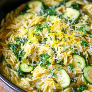 - 1 cup orzo pasta - 3 cups vegetable broth - 1 tablespoon olive oil - 2 cloves garlic, minced - 1 small onion, finely chopped - 1 medium zucchini, diced - 1 cup baby spinach - Zest and juice of 1 lemon - 1/2 cup freshly grated Parmesan cheese - Salt and pepper to taste - Fresh parsley, chopped (for garnish) To make the One Pot Lemon Parmesan Orzo, I use simple measurements. Here’s a quick guide: - Orzo pasta: 1 cup is about 200 grams. - Vegetable broth: 3 cups equals about 720 milliliters. - Olive oil: 1 tablespoon is about 15 milliliters. - Garlic: 2 cloves are roughly 6 grams when minced. - Onion: 1 small onion is about 70 grams. - Zucchini: 1 medium zucchini is about 200 grams. - Baby spinach: 1 cup is roughly 30 grams. - Lemon: The zest and juice from 1 lemon is about 1 tablespoon each. - Parmesan cheese: 1/2 cup is about 50 grams when grated. If you don’t have one of these ingredients, here are some easy swaps: - Orzo pasta: Use any small pasta like ditalini or couscous. - Vegetable broth: Chicken broth works well for a different flavor. - Olive oil: You can use butter or any other cooking oil. - Zucchini: Swap with diced bell pepper or yellow squash. - Spinach: Kale or arugula can be a nice change here. - Parmesan cheese: Try pecorino or nutritional yeast for a vegan twist. These swaps keep your dish fresh and tasty. Enjoy experimenting! Start by gathering your ingredients. You need: - 1 cup orzo pasta - 3 cups vegetable broth - 1 tablespoon olive oil - 2 cloves garlic, minced - 1 small onion, finely chopped - 1 medium zucchini, diced - 1 cup baby spinach - Zest and juice of 1 lemon - 1/2 cup freshly grated Parmesan cheese - Salt and pepper to taste - Fresh parsley, chopped (for garnish) Chop the onion and zucchini. Mince the garlic. This prep makes cooking easier. Heat the olive oil in a large pot over medium heat. Add the chopped onion first. Sauté for about 3-4 minutes until it turns clear. Next, add the minced garlic and diced zucchini. Cook them for another 2-3 minutes. The zucchini should be soft. Now, stir in the orzo pasta and pour in the vegetable broth. Bring the mix to a boil. Once boiling, reduce the heat to low. Cover the pot and let it simmer for about 10-12 minutes. Stir the pot occasionally. The orzo will soak up most of the liquid. After simmering, take the pot off the heat. Stir in the baby spinach, lemon zest, and lemon juice. The heat will wilt the spinach quickly. Finally, mix in the freshly grated Parmesan cheese until it blends well. Add salt and pepper to taste. For the best orzo texture, watch the cooking time. If overcooked, it may become mushy. Keep an eye on the liquid level too. You want it creamy, not soupy. If you like a bit of crunch, add the spinach later. This way, it stays bright and fresh. Using freshly grated cheese makes a big difference in flavor. Garnish with chopped fresh parsley before serving. This adds a nice color and a fresh taste. Enjoy your meal! You can change the taste of your One Pot Lemon Parmesan Orzo easily. Here are some ideas: - Add herbs: Fresh basil or thyme adds a nice touch. - Spice it up: A pinch of red pepper flakes gives heat. - Use different cheese: Try goat cheese or feta for a new flavor. - Citrus zest: Mix in lime or orange zest for a twist. Serve your orzo warm for the best taste. Here are some great ideas: - Pair with protein: Grilled chicken or shrimp complements the dish well. - Add a salad: A fresh green salad balances the meal. - Serve with bread: Crusty bread is great for scooping up orzo. - Garnish: Top with extra parsley and lemon slices for color. Leftover One Pot Lemon Parmesan Orzo can be tasty too. Here’s how to store it right: - Cool it first: Let it cool down before putting it in the fridge. - Use airtight containers: This keeps the orzo fresh and tasty. - Eat within three days: For the best flavor, enjoy leftovers soon. - Reheat gently: Add a splash of broth or water when warming it up. {{image_2}} You can boost the protein in your One Pot Lemon Parmesan Orzo easily. Consider adding cooked chicken, shrimp, or even chickpeas. Each option brings a unique taste and texture. For chicken, use shredded rotisserie for quick prep. If you prefer seafood, add shrimp right before the orzo is done cooking. They only need a few minutes to cook through. For a plant-based choice, chickpeas add a nice bite and protein without meat. To make a vegan version, swap out the Parmesan cheese for nutritional yeast. This gives a cheesy flavor without using dairy. Use vegetable broth to keep it plant-based. You can also add more veggies like bell peppers or mushrooms for extra flavor and texture. If you like creaminess, add a splash of coconut milk after cooking. This makes the dish rich and satisfying. Seasonal vegetables can change the vibe of your dish. In spring, try adding asparagus or peas for freshness. In summer, bell peppers and cherry tomatoes can bring brightness. In fall, consider adding butternut squash or kale for warmth. In winter, root vegetables like carrots or parsnips work well. Just remember to adjust cooking times based on the veggies you choose. Keep the flavors fresh and vibrant to highlight the lemon! After cooking your One Pot Lemon Parmesan Orzo, let it cool down. Place it in an airtight container. Store it in the fridge for up to three days. This way, it stays fresh and tasty. When you’re ready to eat, just take it out. You can also freeze the orzo. First, let it cool completely. Then, scoop it into freezer-safe bags or containers. Press out the air to avoid freezer burn. It can last up to three months in the freezer. When you want to enjoy it again, just thaw it overnight in the fridge. To reheat, you have a few options. You can use the microwave or stovetop. If using the microwave, heat it in short bursts. Stir between each burst to heat evenly. For the stovetop, add a splash of broth or water. Heat it on low, stirring often until warm. This keeps the orzo moist and flavorful. Enjoy your meal! To make One Pot Lemon Parmesan Orzo, follow these easy steps: 1. Heat olive oil in a large pot over medium heat. 2. Add chopped onion and cook until it turns clear. This takes about 3-4 minutes. 3. Next, stir in minced garlic and diced zucchini. Cook for another 2-3 minutes. 4. Add orzo pasta and vegetable broth. Bring to a boil. 5. Once boiling, lower the heat, cover the pot, and simmer for 10-12 minutes. Stir often. 6. After the orzo absorbs most of the liquid, remove it from heat. 7. Mix in baby spinach, lemon zest, and lemon juice. The heat will wilt the spinach. 8. Finally, fold in freshly grated Parmesan cheese and season with salt and pepper. 9. Garnish with chopped parsley before serving. This dish is quick, tasty, and perfect for a weeknight meal. Yes, you can use other pasta shapes for this recipe. Some great options include: - Penne - Fusilli - Farfalle Keep in mind that cooking times may vary. Check the package for guidance. The flavors will still shine through, making it a fun twist! One Pot Lemon Parmesan Orzo pairs well with various sides. Here are some ideas: - Grilled chicken or shrimp - A light salad with mixed greens - Roasted vegetables like bell peppers or carrots These sides add more texture and flavor. Feel free to mix and match based on what you enjoy! This article covers the key points for making One Pot Lemon Parmesan Orzo. You learned about the ingredients, how to prepare and cook them, and ways to achieve a great texture. We explored tips for customizing flavors and serving ideas. You gained insights into variations like protein add-ins and vegan options. Lastly, we discussed proper storage and reheating methods. Remember to try different ingredients to make this dish your own. Enjoy your cooking adventure and savor every bite!