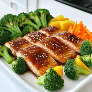 To make Teriyaki Salmon Sheet Pan with Broccoli, gather these fresh items: - 4 salmon fillets - 2 cups broccoli florets - 1 bell pepper, sliced (red or yellow) - 1 medium carrot, julienned - 1/4 cup soy sauce (low sodium) - 2 tablespoons honey - 2 tablespoons sesame oil - 1 tablespoon rice vinegar - 2 garlic cloves, minced - 1 teaspoon ginger, grated - 1 tablespoon sesame seeds (for garnish) - Salt and pepper to taste - Cooked rice or quinoa (for serving, optional) These ingredients combine to create a dish full of flavor and nutrition. When you choose fresh salmon, look for bright color and a firm texture. The vegetables add crunch and color. Each component works together to make your meal both tasty and healthy. The teriyaki marinade gives a sweet and savory touch. You can adjust the flavors to suit your taste, making this recipe fun and flexible. Enjoy cooking! First, set your oven to 400°F (200°C). This temperature helps cook the salmon and veggies just right. It also makes sure everything bakes evenly. Preheating is key for great results. Next, grab a small mixing bowl. Add 1/4 cup of low-sodium soy sauce. Then, mix in 2 tablespoons of honey for sweetness. Pour in 2 tablespoons of sesame oil to give it a rich flavor. Now, add 1 tablespoon of rice vinegar for a little tang. Don't forget 2 minced garlic cloves and 1 teaspoon of grated ginger for a burst of taste. Whisk everything together until smooth. This marinade adds a tasty glaze to the salmon. Now, take a large sheet pan and line it with parchment paper. Place 4 salmon fillets on one side of the pan. Season each fillet with salt and pepper. Then, brush them with the teriyaki marinade. On the other side, arrange 2 cups of broccoli florets, 1 sliced bell pepper, and 1 medium julienned carrot. Drizzle a bit of sesame oil over the veggies and season with salt and pepper. Pour any leftover marinade over the vegetables. This step helps everything soak up the flavors. Slide the sheet pan into your preheated oven. Bake for about 15-20 minutes. You’ll know it’s done when the salmon flakes easily and the veggies are tender but crisp. The salmon should look glossy and caramelized. Once it's ready, take the pan out of the oven. Let it cool for a few minutes. Sprinkle 1 tablespoon of sesame seeds over the salmon and veggies for a nice touch. Serve your teriyaki salmon and vegetables warm over cooked rice or quinoa if you like. When picking salmon, look for bright, shiny skin. The flesh should be firm and moist. Fresh salmon smells like the sea, not fishy. Wild-caught salmon often tastes better than farmed. Varieties like sockeye or king have rich flavors. If you can, buy salmon from a trusted source. Always check the sell-by date to ensure freshness. The teriyaki marinade is key to this dish. Use low-sodium soy sauce for a balanced taste. Honey adds sweetness, while sesame oil gives a nutty flavor. Rice vinegar adds a tangy kick. For depth, don't skip the garlic and ginger. Mix all ingredients well. Let the salmon marinate for at least 15 minutes for the best flavor. To keep your vegetables crisp, don't overcook them. Arrange them on the sheet pan in a single layer. This helps them cook evenly. Drizzle a little sesame oil on top for extra flavor. Season with salt and pepper, but don’t drown them. Bake until they are bright in color and tender but still crunchy. Serve the teriyaki salmon over warm rice or quinoa. This adds a nice base and absorbs the sauce. Top with fresh herbs like cilantro or green onions for color. A sprinkle of sesame seeds adds a lovely crunch. You can also add lime wedges for a zesty twist. Enjoy your meal with a side salad for balance. {{image_2}} You can change up the veggies in this dish. Use snap peas for a crisp bite. Carrots add color and sweetness. Zucchini slices cook fast and soak up flavor. Cauliflower florets are a great option too. Each veggie brings its own taste and texture. Feel free to mix and match based on what you love. Not a fan of teriyaki? Try a honey mustard glaze. Mix honey, mustard, and a splash of vinegar for a tangy kick. You can also use a simple lemon and herb mix. This brings a fresh taste that pairs well with salmon. Barbecue sauce can add a smoky flavor. Choose a sauce that excites your taste buds. Baking is easy, but you can grill the salmon too. This adds a nice char and smoky flavor. Cooking it in a skillet works well for a quick meal. Just sear the salmon on medium heat. If you have a steamer, use it for tender salmon. Each method gives a unique taste to your dish. Experiment to find your favorite way! After enjoying your teriyaki salmon, let any leftovers cool down. Place the salmon and veggies in an airtight container. This keeps them fresh longer. You can store them in the fridge for up to three days. Make sure to cover them well to keep out air. To reheat your salmon, you can use the oven or a microwave. If using the oven, set it to 350°F (175°C). Place the salmon and veggies on a baking sheet. Heat for about 10 minutes or until warmed through. If you prefer the microwave, heat in short bursts, about 30 seconds at a time. Check often to avoid overcooking. You can freeze leftover teriyaki salmon for later. Wrap each fillet tightly in plastic wrap. Then, place them in a freezer-safe bag or container. This keeps the salmon fresh for up to three months. When you are ready to eat, thaw it in the fridge overnight and reheat as mentioned above. You can serve teriyaki salmon with cooked rice or quinoa. Both options soak up the sauce well. You can also add a side of fresh salad for a crunchy feel. Sliced cucumbers with a bit of vinegar make a nice touch. Adding a fruit salad can bring sweetness to your meal. Yes, you can prep the salmon and vegetables ahead of time. Marinate the salmon and chop the veggies. Store them in the fridge for up to a day. When you are ready, just bake them. This saves time and makes dinner easy. The salmon is done when it flakes easily with a fork. It should look glossy and have a nice caramelized color on top. For safety, the internal temperature should reach 145°F (63°C). Use a food thermometer for the best results. To make this recipe gluten-free, use tamari instead of soy sauce. Tamari is a great substitute that tastes similar. Check the labels on honey and other sauces to ensure they are gluten-free too. This way, you can enjoy teriyaki salmon without worry. This blog post explains how to make teriyaki salmon, covering ingredients and steps. I provided tips for choosing salmon and using fresh vegetables. You can also explore variations and smart storage tips. In the end, cooking teriyaki salmon is simple and fun. Enjoying this tasty meal can impress your family and friends. Experiment with flavors and ingredients to make it your own. Enjoy your cooking adventure!