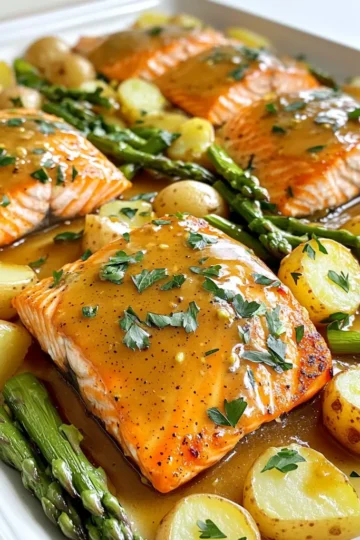 - 4 salmon fillets (about 6 oz each) - ¼ cup Dijon mustard - ¼ cup honey - 2 tablespoons olive oil - 1 tablespoon apple cider vinegar - 3 cloves garlic, minced - 1 teaspoon smoked paprika - Salt and pepper to taste - 1 pound baby potatoes, halved - 1 pound asparagus, trimmed - Fresh parsley, chopped (for garnish) To make this dish, you need fresh salmon fillets, which are key for flavor. The honey mustard glaze gives a sweet and tangy kick. I love using baby potatoes and asparagus for sides. They roast well and add color to the plate. - Sheet pan - Parchment paper - Mixing bowl - Whisk You will want a sheet pan for even cooking. Parchment paper helps with cleanup and keeps the food from sticking. A mixing bowl and whisk are perfect for blending the honey mustard glaze. This setup makes the process quick and easy. 1. Preheating the oven Start by preheating your oven to 400°F (200°C). This step is key to cooking your meal evenly. 2. Preparing the honey mustard mixture In a small bowl, combine ¼ cup Dijon mustard and ¼ cup honey. Add 2 tablespoons olive oil and 1 tablespoon apple cider vinegar. Mix in 3 cloves minced garlic, 1 teaspoon smoked paprika, salt, and pepper to taste. Whisk everything until smooth. This will be your tasty glaze! 1. Baking the potatoes Place 1 pound of halved baby potatoes on one side of your sheet pan. Drizzle half of your honey mustard mixture over the potatoes. Toss them gently to coat. Bake these potatoes in the oven for 15 minutes. This gives them a head start. 2. Adding salmon and asparagus After 15 minutes, take the pan out. Lay 4 salmon fillets in the center of the pan. Spoon the rest of the honey mustard glaze on top of the salmon. Now, add 1 pound of trimmed asparagus on the other side of the pan. Drizzle a bit of olive oil over the asparagus and season with salt and pepper. Return the pan to the oven for another 15-20 minutes. Keep an eye on the salmon. It should flake easily with a fork, and the asparagus should be tender. 1. Resting time and garnishing Once everything is cooked, take the pan out of the oven. Let it rest for a few minutes. This helps the salmon stay juicy. Before serving, sprinkle chopped fresh parsley on top for a nice finish. Your sheet pan honey mustard salmon is now ready to impress! Achieving optimal doneness To cook salmon just right, aim for an internal temperature of 145°F. You can check this with a food thermometer. The fish should flake easily with a fork when done. If you want it a bit less cooked, remove it around 130°F for medium-rare. Remember, it will continue to cook after you take it out of the oven. Flavor variations with marinade You can change the flavor by adding different herbs or spices. Try dill or thyme for a fresh taste. You can also use maple syrup instead of honey for a sweeter twist. Just keep the base of Dijon mustard for that zingy kick. Feel free to experiment and find your favorite combination! Preventing sticking and ensuring even cooking Always use parchment paper to line your sheet pan. This helps prevent sticking and makes cleanup easier. Make sure to space the salmon and veggies out on the pan. This way, they cook evenly and get that nice roasted flavor. Don’t overcrowd the pan; it can cause steaming instead of roasting. Efficient cleanup methods To make cleanup a breeze, soak your mixing bowl and utensils right after using them. This will help loosen any sticky residue. If you used oil on your veggies, sprinkle some salt on the pan after serving. This can help absorb excess grease before washing. Finally, use hot, soapy water for an easy clean! {{image_2}} You can swap Dijon mustard for whole grain mustard. This change adds a nice texture. You may also use yellow mustard if that's what you have. Honey can be replaced with maple syrup for a sweeter twist. Agave syrup is a good option too. For vegetables, you can add bell peppers or zucchini. Carrots also work great. Feel free to mix in your favorite vegetables. Just make sure to cut them into similar sizes for even cooking. Serve this dish with rice or quinoa for a hearty meal. A light salad with greens and a vinaigrette pairs well too. You might enjoy roasted carrots or green beans as a side. For drinks, white wine like Sauvignon Blanc is a perfect match. If you prefer non-alcoholic drinks, try sparkling water with lemon. A light iced tea also complements this meal nicely. To store leftovers, let the salmon cool down first. Place the salmon, potatoes, and asparagus in an airtight container. You can store it in the fridge for up to three days. If you want to keep it longer, consider freezing it. Wrap the food tightly with plastic wrap, then place it in a freezer bag. This way, it can last up to three months in the freezer. Reheating leftovers can be tricky, but I have some tips. For the best results, use an oven. Preheat your oven to 350°F (175°C). Place the salmon and veggies on a baking sheet. Cover them with aluminum foil to keep moisture in. Heat for about 15-20 minutes, or until warmed through. This method keeps the salmon flaky and the veggies tender. If you're in a hurry, you can use a microwave. Just warm it in short bursts, checking often to avoid drying it out. Can I use frozen salmon? Yes, you can use frozen salmon. Just make sure to thaw it first. Place the frozen fillets in the fridge overnight. If you’re in a hurry, you can also run them under cold water for a few minutes. Just remember that cooking times may be a bit longer for frozen salmon. How do I know when the salmon is done? Salmon is done when it flakes easily with a fork. It should have an internal temperature of 145°F (63°C). You can use a meat thermometer for accuracy. The salmon should look opaque and moist, not dry. Caloric content and health benefits This dish is packed with nutrients. Each serving has around 400 calories. Salmon is rich in omega-3 fatty acids, which are great for your heart. The honey and mustard add flavor without too many extra calories. Plus, you get fiber from the asparagus and potatoes. Can this recipe be made low-carb? Yes, you can make this recipe low-carb. Simply replace the potatoes with cauliflower or zucchini. These veggies provide a similar texture without the carbs. You still get the tasty honey mustard flavor with the salmon and asparagus. In this blog post, you learned how to make honey mustard salmon with easy steps. We covered ingredients, tools, and tips for perfect cooking. You can experiment with substitutes and meal pairings for great variety. Remember to store leftovers properly and follow reheating tips for best flavor. Cooking doesn't have to be hard. With these easy steps, you’ll impress friends and family with your new dish. Enjoy the deliciousness and healthy benefits of your honey mustard salmon!