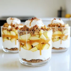 - 2 large apples (Granny Smith or Honeycrisp), diced - 1 cup Greek yogurt (vanilla flavor) - 1/2 cup granola (your choice) - 1/4 cup caramel sauce (store-bought or homemade) - 1/2 teaspoon cinnamon - 1 tablespoon lemon juice - Whipped cream (optional, for garnish) - Chopped nuts (optional, such as walnuts or pecans, for added crunch) For this recipe, I prefer using Granny Smith or Honeycrisp apples. These types give a great mix of tart and sweet. You can dice them easily to fit into your parfait. I always choose vanilla Greek yogurt. It adds a creamy texture and a slight sweetness. You can use plain yogurt if you want less sugar. Granola is a fun part of this recipe. Choose your favorite brand or make your own. It adds crunch and flavor. You can use store-bought caramel sauce for quick prep. If you want to make it special, try homemade caramel. It tastes rich and fresh. A little cinnamon goes a long way. It adds warmth and spice. Lemon juice keeps the apples bright and fresh. For a fun touch, add whipped cream on top. It makes the parfait feel fancy. Also, sprinkle some chopped nuts like walnuts or pecans for extra crunch. Gather these ingredients, and you’re ready to create a delicious dessert or snack! Start by dicing two large apples. I like using Granny Smith or Honeycrisp for their crisp texture. In a medium bowl, mix the diced apples with 1 tablespoon of lemon juice and 1/2 teaspoon of cinnamon. This step is key. The lemon juice stops the apples from browning, and the cinnamon adds nice flavor. Now, gather your parfait glasses or bowls. Begin with a layer of Greek yogurt at the bottom of each glass, about 1/4 cup per serving. This creamy base is essential for a rich taste. Next, spoon a third of the apple mixture over the yogurt. Drizzle 1 tablespoon of caramel sauce on top of the apples. The caramel adds a sweet touch. After that, sprinkle about 2 tablespoons of granola over the caramel for crunch. Repeat these layers until your glass is full. Finish with a layer of yogurt and a drizzle of caramel sauce. If you want to make it special, add a dollop of whipped cream on top. You can also sprinkle some chopped nuts, like walnuts or pecans, for extra texture. Serve these parfaits right away, or you can refrigerate them for up to an hour. This wait helps the flavors blend nicely. When making caramel apple yogurt parfaits, the right apple matters. I recommend using Granny Smith or Honeycrisp apples. - Granny Smith: This variety is tart and crisp. It balances well with sweet caramel. - Honeycrisp: This apple is sweet and juicy. It adds a pleasant crunch to your parfait. You can mix these apples for a fun flavor twist! You can switch up the yogurt and granola to fit your taste. Use any yogurt flavor you love. Greek yogurt adds creaminess, but you can go for dairy-free too. For granola, choose your favorite. - Substitutes: Try coconut yogurt or almond milk yogurt for a dairy-free option. - Flavor Variations: Add spices like nutmeg or ginger for extra warmth. You can also use vanilla or almond extract to enhance the flavor. How you serve your parfaits can make a big difference. Use clear glassware to show off those beautiful layers. - Different Glassware: Mason jars or small bowls work great. They add charm to your dish. - Garnishing Tips: Top with a sprinkle of nuts or a drizzle of caramel. This makes your parfaits look even more tempting! These tips will help you create a delicious and beautiful dessert that everyone will love! {{image_2}} You can change the flavors of caramel apple yogurt parfaits with the seasons. For fall, try adding pumpkin puree or diced pears. This will give your parfait a warm, cozy feel. The pumpkin adds creaminess, while the pear offers sweetness. In the summer, mix in berries like strawberries, blueberries, or raspberries. Their bright flavors and colors make your parfait fun and fresh. Just replace some apple with your chosen berries. This twist keeps the dish vibrant and delicious. If you're looking for gluten-free options, choose gluten-free granola. Many brands offer tasty blends that fit this need. They still add crunch and flavor to your parfait. For those needing dairy-free options, swap Greek yogurt for a dairy-free yogurt. Almond or coconut yogurt works well. They offer a creamy texture without the dairy. Make sure to check the label for added sugars or artificial flavors. You can easily adjust the parfait for breakfast or dessert. For breakfast, stick to yogurt, apples, and granola. This keeps it light and healthy. If you want a dessert, add more caramel and whipped cream. You can also layer in chocolate or nuts for extra richness. This way, you can enjoy the same base recipe but switch it up for any meal! You can store the parfaits in the fridge for up to one day. Keep them in an airtight container. This will keep them fresh and tasty. After one day, the apples may brown and the granola can get soggy. If you want, you can separate the layers in different containers. This helps keep everything fresh longer. You can freeze these parfaits, but it’s not the best idea. Freezing can change the texture of the yogurt and apples. If you still want to freeze them, here are some tips: - Use freezer-safe containers to avoid freezer burn. - Freeze the layers separately, if possible. This helps maintain their original taste and texture. - When ready to eat, thaw in the fridge overnight. Enjoy them within a week. If you have extra yogurt, apples, or granola, there are many fun ways to use them: - Mix yogurt with fruits for a smoothie. - Use leftover apples in muffins or pancakes. - Top yogurt with granola for a quick snack. - Add granola to salads for a crunchy kick. Getting creative with leftovers helps reduce waste and adds variety to your meals. Yes, you can prepare these parfaits one hour ahead. Layer them in glasses, then cover and chill in the fridge. The flavors blend well in this time. However, store the apples separately if you want them crisp. Mix diced apples with lemon juice and cinnamon. This method keeps the apples fresh and tasty. The lemon juice slows browning, while cinnamon adds a warm flavor. To make dairy-free parfaits, use coconut yogurt or almond yogurt instead of Greek yogurt. Both options provide a creamy texture. You can also use a dairy-free caramel sauce for sweetness. Absolutely! You can try flavored yogurt, like honey or maple. Non-dairy options also work well. Just pick a yogurt that matches your taste. To make these parfaits healthier, use low-sugar granola. You can add chia seeds for extra fiber. Try mixing in some fresh berries or nuts for added nutrients and crunch. You now have all the tools to create your own amazing parfaits. Use your favorite apples and yogurt for the best taste. Don’t forget to mix in lemon juice and cinnamon to keep apples fresh. Feel free to customize your recipe with seasonal fruits or dietary needs. Store extras wisely to enjoy later. Making parfaits is fun and easy, perfect for breakfast or dessert. Try different toppings to keep it exciting. Dive into this delicious treat for any meal and enjoy!