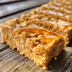 - 2 cups rolled oats - 1 cup natural peanut butter - ½ cup honey or maple syrup To make these three ingredient peanut butter oat bars, you only need a few simple items. First, you will need 2 cups of rolled oats. This gives the bars a great texture. Next, grab 1 cup of natural peanut butter. This will add both flavor and creaminess. Finally, choose ½ cup of honey or maple syrup for sweetness. Using honey will give a rich taste, while maple syrup offers a unique twist. You can mix and match these ingredients based on your preference. This recipe is flexible and fun! - Step 1: Preheat oven and prepare the baking dish First, set your oven to 350°F (175°C). Next, grab an 8x8 inch baking dish. Line it with parchment paper. Leave some paper over the edges. This helps you lift out the bars later. - Step 2: Combine ingredients in a mixing bowl In a large mixing bowl, add 2 cups of rolled oats, 1 cup of natural peanut butter, and ½ cup of honey or maple syrup. Mix these three ingredients well. You want a sticky mixture that holds together. - Step 3: Transfer mixture to the baking dish Now, take your oat mixture and pour it into the prepared baking dish. Use a spatula to spread it evenly. Press it down firmly. This makes sure the bars stay together when baked. - Step 4: Bake and cool the bars Place the dish in the oven. Bake for 15-20 minutes. Watch for the edges to turn golden brown. When done, take it out and let it cool for about 10 minutes in the pan. Use the parchment to lift out the bars. Let them cool completely on a wire rack. Once cool, cut them into bars of your choice. To get the right texture, mix well. You want a sticky and thick blend. Start with the rolled oats. Add the peanut butter and honey. Stir until no dry oats remain. Use a spatula to help combine. If it feels too dry, add a bit more honey. For even distribution, use your hands or a spatula. Press the mix into the baking dish firmly. This helps the bars hold together. Make sure to spread it out to the edges. An even layer makes for better baking. Ovens can vary, so keep an eye on your bars. Bake for 15 to 20 minutes. Check for a golden edge. This color shows they are ready. If your oven runs hot, check for doneness early. You’ll know the bars are done when they feel firm. The center should not jiggle. Let them cool in the pan for 10 minutes. This step helps them set up better. After, lift them out using the parchment paper. {{image_2}} You can easily change the taste of your peanut butter oat bars. Adding chocolate chips gives a sweet twist. I love using dark chocolate chips for a rich flavor. You can mix in nuts or seeds, too. Chopped almonds or sunflower seeds add crunch and nutrition. This way, you make the bars even more fun to eat. If you want a different kind of sweetness, try agave nectar instead of honey. Agave has a mild flavor and is less sticky. You can also use coconut sugar for a deeper taste. Coconut sugar adds a hint of caramel. Both options work well and keep the bars tasty! To keep your peanut butter oat bars fresh, store them in an airtight container. You can keep them at room temperature for up to three days. If you want them to last longer, put them in the fridge. They stay good in the fridge for about a week. Just make sure the container is sealed tight to prevent them from drying out. These bars can last up to a week in the fridge. At room temperature, they last about three days. Watch for signs of spoilage, like an off smell or mold. If the bars feel hard or dry, it's best to throw them away. Always check before you snack! Yes, you can use almond butter or sunflower seed butter. These options work well. Keep in mind that the flavor will change a bit. Almond butter gives a nutty taste, while sunflower seed butter is more neutral. Make sure any substitute is natural and smooth. Look for golden brown edges. You want the bars firm but not too hard. If the top is slightly puffed, that’s a good sign too. You can also do a toothpick test. Insert it into the center. If it comes out clean, your bars are done! Yes, these bars are gluten-free if you use certified gluten-free oats. Regular oats may have gluten due to cross-contamination. Check the package to be sure. This makes them great for those with gluten sensitivities. Absolutely! Freezing is a great option. Wrap the bars tightly in plastic wrap or foil. Place them in an airtight container or freezer bag. They can last up to three months in the freezer. Just thaw them in the fridge when you're ready to enjoy! You learned how to make delicious oat bars with simple steps. We covered ingredients, preparation, tips, and variations. Remember to store them properly for the best taste. Enjoy these bars as snacks or treats. With a few tweaks, you can customize them to your liking. Now, you have the know-how to create tasty oat bars anytime. Dive in and start baking! Your kitchen adventures await.
