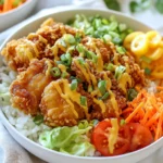 - 1 lb boneless, skinless chicken thighs - 1 cup buttermilk (or dairy-free alternative) - 1 cup all-purpose flour - ½ cup cornstarch - 1 teaspoon garlic powder - 1 teaspoon onion powder - ½ teaspoon cayenne pepper (adjust to taste) - Salt and black pepper to taste - ½ cup mayonnaise - 2 tablespoon sweet chili sauce - 1 teaspoon Sriracha sauce (adjust for heat) - 1 teaspoon lime juice - 1 cup cooked jasmine or basmati rice - 1 cup shredded iceberg lettuce - ½ cup shredded carrots - ½ cup cherry tomatoes, halved - ¼ cup sliced green onions To make a Crispy Bang Bang Chicken Bowl, you need fresh and tasty ingredients. The chicken thighs provide great flavor. Soaking them in buttermilk makes them juicy. If you need a dairy-free version, choose a dairy-free milk like almond or oat. The coating is key for that crispy crunch. Flour and cornstarch blend together to create a perfect texture. The seasoning adds flavor. Garlic and onion powders bring depth. Cayenne gives a mild heat. Adjust it to your liking. The Bang Bang sauce adds a creamy and spicy touch. Mayonnaise is the base. Sweet chili sauce gives it sweetness. Sriracha adds heat, and lime juice gives brightness. Mix these to create the perfect sauce. Don’t forget the base and veggies! Cooked jasmine or basmati rice makes a great foundation. Shredded iceberg lettuce adds crunch. Shredded carrots and halved cherry tomatoes add color and nutrients. Green onions finish the bowl with a fresh kick. Gather these ingredients, and you'll be ready for a fun cooking adventure! {{ingredient_image_1}} - Marinate the Chicken: Start by soaking the chicken thighs in buttermilk. This is best done for at least 1 hour or overnight. The buttermilk makes the chicken tender and juicy. - Prepare the Coating: In a bowl, mix the flour, cornstarch, garlic powder, onion powder, cayenne pepper, salt, and black pepper. This mix gives the chicken a nice crunch. - Heat the Oil: In a deep skillet, add about 1 inch of vegetable oil. Heat it over medium-high heat until it shimmers. This means it’s ready for frying. - Coat the Chicken: Take the marinated chicken out of the buttermilk. Let any extra buttermilk drip off. Now, dredge each piece in your flour mixture. Make sure each piece is fully coated and shake off the extra flour. - Fry the Chicken: Carefully place the coated chicken in the hot oil. Fry for 5-7 minutes on each side until golden brown and cooked through. Use batches if needed. Place the fried chicken on a paper towel-lined plate to drain excess oil. - Make the Bang Bang Sauce: In a small bowl, mix the mayonnaise, sweet chili sauce, Sriracha, and lime juice. Stir well until it’s smooth. This sauce adds a tasty kick to your dish. - Assemble the Bowl: In each serving bowl, start with a scoop of rice. Then, add the crispy chicken pieces. Next, layer on the shredded lettuce, carrots, halved cherry tomatoes, and green onions. - Drizzle Sauce: Finish your bowl by drizzling the Bang Bang sauce generously over the top. Enjoy your vibrant and tasty meal! Soak the chicken thighs in buttermilk for at least one hour. For more flavor, soak overnight. This makes the chicken tender and juicy. If you want a dairy-free option, use almond milk or coconut milk mixed with a bit of lemon juice. This gives a similar tangy taste. Check the oil temperature before frying. Heat it until it shimmers, about 350°F (175°C). Use a thermometer for accuracy. Fry the chicken in small batches. This helps them cook evenly and stay crispy. Avoid crowding the pan, as this lowers the oil temperature. For garnishing, use sliced green onions and sesame seeds. They add color and crunch. Serve each bowl with a lime wedge on the side. A fresh squeeze of lime brightens the flavors. Keep the bowls colorful and fresh by layering veggies neatly. Pro Tips Marination Matters: Allowing the chicken to marinate in buttermilk overnight enhances tenderness and flavor, making for a juicier bite. Perfect Oil Temperature: Ensure your oil is hot enough (around 350°F) before frying to achieve a crispy coating and avoid greasy chicken. Batch Frying: Fry the chicken in small batches to maintain the oil temperature, which ensures even cooking and crispiness. Customize the Sauce: Adjust the spiciness of the Bang Bang sauce by modifying the amount of Sriracha, or substitute with your favorite hot sauce for a unique twist. {{image_2}} You can enjoy a healthier version of the Crispy Bang Bang Chicken Bowl. One great option is to bake the chicken instead of frying it. This cuts down on oil and keeps the chicken juicy. For a baked version: - Preheat your oven to 400°F (200°C). - Place the coated chicken on a baking sheet lined with parchment paper. - Bake for about 25-30 minutes, flipping halfway through, until golden and crispy. You can also offer gluten-free choices. Simply swap all-purpose flour with gluten-free flour or almond flour. This way, everyone can enjoy the meal without worry. You can customize the Bang Bang sauce to match your taste. If you like more heat, add extra Sriracha or chili sauce. For a sweeter sauce, increase the sweet chili sauce. Mixing in different veggies adds flair to your bowl. Try bell peppers, cucumbers, or snap peas for a crunch. You can also use herbs like cilantro or basil for fresh flavor. If you want a change from chicken, shrimp works well. Just adjust cooking time to avoid overcooking. For a plant-based option, use tofu. Firm tofu absorbs flavors nicely and adds a nice texture. You can also make a vegetarian bowl with all the veggies and rice. It’s a great way to enjoy the same flavors without meat. To keep your Crispy Bang Bang Chicken Bowl fresh, store leftovers properly. Place the chicken and rice in separate airtight containers. This helps keep the chicken crispy and the rice fluffy. Refrigerate them within two hours of cooking. For best results, use the fridge's colder sections. If you want to freeze leftovers, let them cool first. Wrap chicken pieces tightly in plastic wrap, then in foil. Store rice in a separate container. This keeps moisture out. Label containers with the date to track freshness. The best way to reheat crispy chicken is in an oven or air fryer. Preheat your oven to 375°F. Place the chicken on a baking sheet. Heat for about 10-15 minutes until crisp. If using an air fryer, set it to 375°F and heat for 5-8 minutes. Avoid using the microwave, as it can make the chicken soggy. To keep the rice moist, add a splash of water before reheating. Cover the dish with a damp paper towel and microwave for 1-2 minutes. When stored properly, the Crispy Bang Bang Chicken Bowl lasts 3-4 days in the fridge. If frozen, it can last up to 3 months. Always check for signs of spoilage. Look for off smells, changes in color, or a slimy texture. If you notice any of these, it's best to discard the dish. A Bang Bang Chicken Bowl is a tasty dish featuring crispy chicken, rice, and fresh veggies. It combines flavors from Asian cuisine, especially Thai and American. The name "Bang Bang" comes from the spicy sauce that adds a kick to the chicken. This dish is great for a quick meal that feels special. Yes, you can make the Bang Bang sauce ahead of time. Just mix mayonnaise, sweet chili sauce, Sriracha, and lime juice in a bowl. Store it in the fridge for up to three days. This way, you save time when preparing your meal. Just remember to give the sauce a good stir before using it. For this recipe, jasmine or basmati rice works best. Both types are fluffy and have a nice aroma. You can cook the rice in water or broth for extra flavor. Follow the package instructions for the best results. If you want to save time, you can use pre-cooked rice. You can easily adjust the heat level of the sauce. To make it milder, reduce the amount of Sriracha. For more heat, add extra Sriracha or a pinch of cayenne pepper. Taste the sauce as you mix it to get the right balance for your preference. This blog post showed you how to make a tasty Bang Bang Chicken Bowl. We covered the ingredients, preparation steps, cooking methods, tips for success, and options for variations. With easy steps and fun ideas, you can enjoy this dish any way you like. Remember, cooking is about trying new things. So, grab your ingredients, have fun, and make a meal you’ll love! Enjoy the process and share your creations with others.