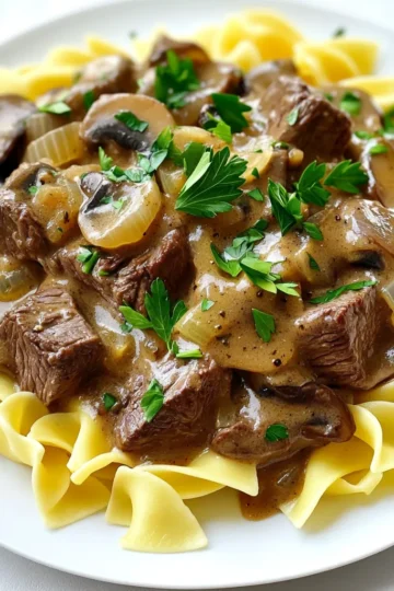 - 2 pounds beef chuck, cut into 1-inch cubes - 1 medium onion, chopped - 3 cloves garlic, minced - 8 ounces mushrooms, sliced To make a great beef stroganoff, you need the best beef chuck. It has flavor and tenderness. Cut it into 1-inch cubes for even cooking. Next, use one medium onion, chopped finely. This adds sweetness and depth. Don’t forget the garlic! Three minced cloves bring a warm aroma. Lastly, use eight ounces of sliced mushrooms. They add a lovely texture and richness. - 1 cup beef broth - 1 tablespoon Worcestershire sauce - 1 teaspoon dried thyme - 1 teaspoon paprika - ½ teaspoon black pepper For taste, beef broth is key. Use one cup for a savory base. Add a tablespoon of Worcestershire sauce for a tangy kick. Season with one teaspoon of dried thyme and one teaspoon of paprika for that depth of flavor. A half teaspoon of black pepper gives it a little heat. - 1 cup sour cream - 3 tablespoons all-purpose flour - Salt to taste To make it creamy, you’ll need one cup of sour cream. This gives a rich, smooth texture. Use three tablespoons of all-purpose flour to help thicken the sauce. Lastly, don’t forget the salt! Adjust it to your taste. Start by searing the beef cubes. Heat olive oil in a large skillet over medium-high heat. Add the beef cubes and season them with salt and pepper. Sear the beef until it turns brown on all sides, which takes about 5 minutes. Once browned, transfer the beef to the slow cooker. Next, it's time to cook the vegetables. In the same skillet, add the chopped onion and minced garlic. Sauté these for 2-3 minutes until they soften. Then, add the sliced mushrooms and cook for an additional 3-4 minutes. Once done, transfer the vegetable mix to the slow cooker with the beef. Now, mix everything together. Pour in the beef broth, Worcestershire sauce, dried thyme, and paprika. Stir to combine all the ingredients. Cover the slow cooker and set it to cook on low for 7-8 hours or on high for 4-5 hours. The beef should be tender when it’s ready. About 30 minutes before serving, we will thicken the sauce. In a small bowl, whisk together the sour cream and flour until smooth. Gradually stir this mixture into the slow cooker. This will help thicken the sauce. Taste and adjust seasoning with more salt and pepper if needed. While your stroganoff cooks, prepare your egg noodles or rice. Follow the package instructions to cook them. Serve the beef stroganoff over the noodles or rice. Don’t forget to garnish with fresh parsley for a nice touch! For beef stroganoff, the best cut is beef chuck. It is tough but becomes tender when cooked slowly. Beef chuck has a rich flavor, which makes your dish taste great. This cut is also budget-friendly, so it's a win-win for cooks. To boost flavor, consider adding a few extra seasonings. Try a pinch of garlic powder or some fresh herbs like thyme and rosemary for extra taste. You can also serve your stroganoff with egg noodles or rice. These sides soak up the sauce and make every bite delicious. To achieve the right sauce consistency, stir in the sour cream and flour mixture slowly. This keeps the sauce smooth. A common mistake is adding the sour cream too early, which can curdle. Always wait until the end of cooking to thicken the sauce. {{image_2}} You can switch out the mushrooms to change the flavor. Try using shiitake or portobello mushrooms. Each type adds its own taste and texture. You can also mix in other veggies like carrots or bell peppers. They will add color and nutrition to your dish. If you want something different, swap the beef for chicken or turkey. Both work well and keep the dish tasty. For a vegetarian option, use mushrooms and add lentils. This keeps the dish hearty without meat. To make this recipe gluten-free, use gluten-free flour instead of all-purpose flour. You can also serve the stroganoff over zoodles or rice. These options taste great and fit gluten-free diets perfectly. To store leftovers, let the beef stroganoff cool to room temperature. Then, place it in an airtight container. This helps keep the flavors fresh. I suggest using glass or BPA-free plastic containers. These containers are great for keeping food safe and tasty. For freezing stroganoff, first let it cool. Then, place the stroganoff in a freezer-safe container. Be sure to leave some space at the top for expansion. When you are ready to eat, thaw the stroganoff in the fridge overnight. To reheat, warm it on the stove or in the microwave. Stir well to ensure even heating. In the fridge, beef stroganoff lasts about 3 to 4 days. If you freeze it, it can last for up to 3 months. Look for signs of spoilage like a sour smell or a change in color. If you notice these signs, it's best to discard the stroganoff. Always trust your senses when checking food safety. To make this dish, you need about 15 minutes for prep. Then, slow cook it for 7-8 hours on low or 4-5 hours on high. So, the total time is around 8 hours and 15 minutes. This long cooking time lets the beef get very tender and tasty. You can use frozen beef, but it may change the cooking time. If you use frozen beef, add an extra hour to your cooking time. The beef may not brown as nicely as fresh beef. If you can, thaw the beef first for best results. To thicken the sauce, mix sour cream and flour in a bowl. Make sure it is smooth. Stir this mix into the slow cooker about 30 minutes before serving. This will help the sauce get nice and creamy. You can adjust the seasoning with salt and pepper to your taste. This blog post covered how to make Slow Cooker Beef Stroganoff. You learned about the main ingredients like beef chuck, onions, and mushrooms. We explored seasonings and creamy components that build flavor and texture. I provided step-by-step instructions, along with helpful tips, variations, and storage info. Mastering this dish will impress anyone at your table. Enjoy making it your own with our suggestions. Cooking is fun, so don’t hesitate to experiment!