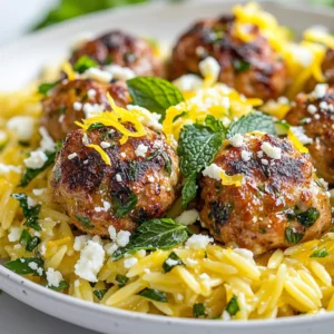 To make Greek chicken meatballs with lemon orzo, you need the following ingredients: - 1 lb ground chicken - 1/4 cup breadcrumbs - 1/4 cup feta cheese, crumbled - 1/4 cup fresh parsley, chopped - 2 cloves garlic, minced - 1 teaspoon dried oregano - 1 teaspoon salt - 1/2 teaspoon black pepper - 1 egg, beaten - 1 tablespoon olive oil (for cooking) - 1 cup orzo pasta - 2 cups chicken broth - 1 lemon (zest and juice) - Fresh mint leaves (for garnish) This mix of ingredients brings a burst of flavor. Ground chicken gives the meatballs a light texture. The feta cheese adds a creamy touch. Fresh parsley and garlic brighten the dish. Oregano gives it a classic Greek taste. The orzo pasta pairs well with the meatballs. Cooking it in chicken broth makes it richer. The lemon zest and juice add a fresh kick. Don’t forget the fresh mint leaves for garnish. They add color and a lovely aroma. Gather these ingredients, and you are ready to create a delightful meal! {{ingredient_image_1}} 1. In a large bowl, gather your ingredients. You need ground chicken, breadcrumbs, feta cheese, parsley, garlic, oregano, salt, pepper, and a beaten egg. 2. Mix these ingredients together gently. Be careful not to overmix, as it can make the meatballs tough. 3. Once combined, form the mixture into small meatballs. Aim for about 1 inch in diameter. This size cooks evenly and makes for nice bites. 1. Heat olive oil in a skillet over medium heat. You want the oil hot enough for frying but not smoking. 2. Add the meatballs in batches. Cook them until golden brown on all sides. This takes about 8 to 10 minutes. Make sure they are cooked through. Once done, remove them from the skillet and set aside. 1. In a saucepan, bring chicken broth to a boil. This broth adds great flavor to the orzo. 2. Add the orzo pasta to the boiling broth. Cook it according to the package instructions. This usually takes about 8 to 10 minutes. 3. When the orzo is tender, drain any excess liquid. Stir in lemon zest and juice. This adds a bright, fresh taste. Season with salt and pepper to your liking. 4. To serve, place the cooked orzo on plates. Top with the Greek chicken meatballs and garnish with fresh mint leaves. Enjoy this delightful dish! Avoiding overmixing When making your meatballs, mix just enough. Overmixing makes them tough. I like to combine the ground chicken, breadcrumbs, and spices gently. You want a nice texture, not a mush. Ensuring even cooking Cook meatballs in batches. This way, they get brown all over. Heat your skillet to medium. Use a little olive oil. Cook for about 8 to 10 minutes, turning them often for even cooking. Suggestions for herbs and spices To boost flavor, add more fresh herbs. Try dill or mint for a twist. If you want heat, add a pinch of red pepper flakes. These small changes can make a big difference. Adjusting lemon flavor Lemon is key in this dish. Zest the lemon for a bright taste. If you like it tart, add more lemon juice. Taste as you go, and adjust to your liking. Presentation tips For a great look, plate the orzo in the center and top with meatballs. Sprinkle some fresh parsley or mint for color. This makes your dish pop and invites everyone to dig in. Complementary side dishes Pair these meatballs with a simple salad. A Greek salad with tomatoes and cucumbers works well. You can also serve it with warm pita bread for a complete meal. Pro Tips Don’t Overmix: When combining the ingredients for the meatballs, mix until just combined to ensure a tender texture. Use Fresh Herbs: Fresh parsley and mint enhance the flavor significantly, so opt for fresh over dried when possible. Cooking Time: Ensure meatballs are cooked through by checking that they reach an internal temperature of 165°F (75°C). Serve with Extra Lemon: A squeeze of fresh lemon juice right before serving brightens the dish and adds a zesty kick. {{image_2}} If you want to switch things up, try using turkey instead of chicken. Turkey gives a leaner option while keeping the flavor nice. For gluten-free choices, use gluten-free breadcrumbs. You can also try quinoa or chickpea flour for a healthy twist. Adding veggies can boost flavor and nutrition. Chopped spinach or bell peppers mix well with meatballs. You can also stir in some diced zucchini. For cheese lovers, try adding goat cheese or Parmesan. Each cheese adds a unique taste to the meatballs. To save time, you can make these meatballs ahead. Form and cook them, then store them in the fridge. They last for about three days. For the orzo, cook it fresh when you’re ready to eat. You can also freeze the meatballs. Just thaw them overnight in the fridge before reheating. To keep your Greek chicken meatballs fresh, follow these tips: - Refrigeration: Place the meatballs in an airtight container. Store them in the fridge for up to 3 days. Make sure they cool down first to avoid steam and sogginess. - Freezing: If you want to keep them longer, freeze the meatballs. Use freezer bags or airtight containers. They can last up to 3 months this way. For best results, freeze them before cooking. When it’s time to enjoy those leftovers, you have two good options: - Microwave: Place the meatballs on a microwave-safe dish. Cover them with a damp paper towel. Heat in short bursts, checking every 30 seconds. This method can dry them out if you’re not careful. - Stovetop: Heat a little olive oil in a skillet over medium heat. Add the meatballs and cover. Cook for about 5-7 minutes, turning occasionally. This method helps keep them moist and flavorful. - To maintain moisture, add a splash of broth or water to the pan while reheating. How long can you keep those tasty leftovers? - In the fridge, Greek chicken meatballs stay good for about 3 days. - In the freezer, they can last up to 3 months. Just remember to label your containers with dates. This way, you’ll know when to use them! Yes, you can. Make the meatballs a day before. Store them in the fridge. This helps save time on busy days. To cook, just heat them up in a pan. You can also freeze the meatballs. Place them in a freezer bag. They can last up to three months. Lemon Orzo pairs well with many sides. Here are some great options: - Grilled vegetables - Greek salad - Tzatziki sauce - Roasted potatoes - Steamed broccoli These sides add color and flavor to your meal. Yes, this recipe is perfect for freezing. Store the meatballs and orzo separately. Use airtight containers or freezer bags. This keeps them fresh. When ready to eat, thaw them overnight in the fridge. Reheat in a pan or microwave. This way, you enjoy a quick, tasty meal anytime. This blog post covered a flavorful Greek chicken meatball recipe with lemon orzo. We explored the key ingredients, simple steps, and useful tips for making the perfect meatballs. I highlighted variations and storage tips to help you enjoy this dish at its best. Overall, these meatballs are easy to make and tasty to enjoy. Try them out; they will add fresh flavor to your meals!