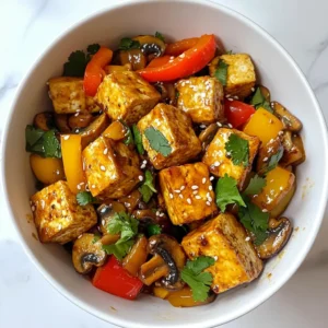 - Firm Tofu (14 oz) - Assorted Mushrooms (2 cups: shiitake, button, oyster) - Vegetable Additions (bell pepper, onion) - Garlic (2 cloves) - Ginger (1 inch) - Soy Sauce (2 tablespoons) - Sesame Oil (1 tablespoon) - Olive Oil (1 tablespoon) - Cornstarch (1 teaspoon, optional) - Sesame Seeds & Fresh Cilantro for Garnish - Salt and Pepper to taste The heart of this Mushroom and Tofu Stir Fry lies in its fresh and vibrant ingredients. Firm tofu gives you a great base. It holds up well during cooking. Use 14 ounces, and don’t forget to drain and press it. This step helps remove excess water and makes it crispier. Next, you need assorted mushrooms. I love using shiitake, button, and oyster mushrooms. They bring different textures and flavors. Two cups is perfect for this dish. Add a sliced bell pepper and a medium onion. These vegetables add color and sweetness to the stir fry. They also provide a nice crunch that you will enjoy in every bite. For flavor, you will need garlic and ginger. Two cloves of minced garlic and a one-inch piece of grated ginger create wonderful aromas. They are essential for that authentic stir fry taste. Soy sauce adds umami, while sesame oil gives a nutty flavor. Use two tablespoons of soy sauce and one tablespoon of sesame oil. Olive oil is also needed to sauté the tofu and vegetables. One tablespoon of olive oil does the trick. If you want a thicker sauce, mix in cornstarch. One teaspoon is enough for a great texture. Finally, sprinkle sesame seeds and fresh cilantro on top for garnish. These add a nice touch and elevate the dish's look. Make sure to season with salt and pepper to taste. This will enhance all the flavors. Enjoy cooking your Mushroom and Tofu Stir Fry! {{ingredient_image_1}} - Start by draining the tofu. Wrap it in a clean towel. Place a heavy object on top to press out moisture. Let it sit for about 15 minutes. This helps the tofu absorb flavors better. - Next, slice the mushrooms and bell pepper. Use a sharp knife for clean cuts. Cut the onion into thin slices. Keep everything ready for quick cooking. - Heat olive oil in a large non-stick skillet or wok. Use medium-high heat for best results. - Add the cubed tofu. Sauté the tofu until it turns golden brown on all sides. This should take about 8 to 10 minutes. Remove the tofu from the skillet and set it aside. - In the same skillet, add the sliced onions. Sauté them until they become translucent, which takes about 3 to 4 minutes. - Add minced garlic and grated ginger. Cook for one more minute, letting the fragrant aroma fill the kitchen. - Toss in the assorted mushrooms and sliced bell pepper. Stir-fry for about 5 to 7 minutes. You want the mushrooms to release their moisture and the veggies to become tender. - Return the sautéed tofu to the skillet. Pour in the soy sauce and sesame oil. Gently toss everything together until well mixed. - If you want a thicker sauce, mix 1 teaspoon of cornstarch with a tablespoon of water to create a slurry. Add the slurry to the stir fry. Stir continuously for 1 to 2 minutes until it thickens. - Season with salt and pepper to taste. Sprinkle sesame seeds on top for extra crunch. - Before serving, garnish the dish with fresh cilantro. This adds a nice pop of color and flavor. Serve it over rice or noodles for a complete meal. Tofu can be tricky, but you want it golden-brown. Start with firm tofu, cut into cubes. Press it well to remove water. Heat olive oil in a skillet. Cook the tofu for about 8-10 minutes. Toss it gently to brown all sides. For extra crispy tofu, try coating it lightly with cornstarch before cooking. This gives it a nice crunch. If you want a gluten-free option, use tamari instead of soy sauce. Tamari has a rich taste that works well in this dish. You can also customize the spice levels. If you love heat, add some chili flakes or sriracha. This will give your stir fry a nice kick and make it exciting. When serving, think about how it looks. You can serve the stir fry over rice or noodles for a hearty meal. For a pop of color, garnish with fresh cilantro and a sprinkle of sesame seeds. Arrange it nicely in a bowl. This not only makes it appetizing but also fun to eat! Pro Tips Press Tofu Well: Ensure the tofu is thoroughly pressed to remove excess moisture, allowing it to absorb flavors better and achieve a crispier texture when sautéed. Variety of Mushrooms: Use a mix of mushrooms for depth of flavor and texture. Shiitake, button, and oyster mushrooms each bring unique tastes that enhance the stir fry. High Heat Cooking: Stir frying requires high heat to cook quickly and evenly. Make sure your skillet or wok is hot before adding ingredients to achieve that signature stir fry sear. Garnish for Freshness: Fresh herbs like cilantro or green onions not only add a pop of color but also brighten the dish's flavors. Add them just before serving for maximum freshness. {{image_2}} You can swap tofu for other proteins. Tempeh offers a nutty taste and firm texture. Seitan is another great choice, with a chewy bite that mimics meat. If you want a legume option, add chickpeas or lentils. They provide a hearty base and boost the dish's fiber. Feel free to get creative with your veggies. Seasonal produce like zucchini, snap peas, or bok choy can add freshness. Mixing different mushroom varieties, like portobello or enoki, can enhance the flavor and texture. Each mushroom brings its unique taste, making your stir fry even more exciting. Want to spice things up? Try adding chili flakes for a kick. Start with a small amount, then increase as needed. For a refreshing twist, incorporate some citrus juice or zest. Lemon or lime can brighten the flavors and balance the richness of the dish. To keep your mushroom and tofu stir fry fresh, store leftovers in the fridge. Use airtight containers for the best results. This dish stays tasty for up to four days. Make sure to let it cool before sealing the container. This helps keep moisture out and flavors in. When reheating, aim to keep the texture just right. I recommend using a skillet over medium heat. Just add a splash of water or broth to keep it moist. Stir gently until warmed through, about five minutes. This method helps the tofu stay soft while the veggies stay crisp. You can freeze your stir fry if you want to save it for later. Divide it into portions and place it in freezer-safe bags. Remove as much air as possible to avoid freezer burn. When you’re ready to eat, thaw it in the fridge overnight. Heat it up in a skillet, and it will taste great! Tofu can get soggy if not prepared well. Here are some tips to keep it firm: - Press the tofu: Wrap it in a clean towel and place something heavy on top. Let it sit for 30 minutes to remove excess water. - Use firm tofu: Firm or extra-firm tofu holds up better in stir fry. - Sauté in hot oil: Heat olive oil first in your skillet. Add cubed tofu and cook until golden brown, about 8-10 minutes. This step adds a nice texture and flavor. Yes, you can easily make this dish gluten-free. Here’s how: - Use tamari: Tamari is a gluten-free soy sauce and works well in this recipe. - Check labels: Always check that your other ingredients are gluten-free. Some sauces and oils may contain gluten. Cooking this dish is quick and easy. Here’s a breakdown: - Prep time: About 15 minutes to chop veggies and press tofu. - Cook time: Around 15 minutes to sauté and stir fry. - Total time: You can have this meal ready in about 30 minutes. Perfect for a busy night! In this post, we explored how to create a tasty tofu and mushroom stir fry. We covered essential ingredients, flavor enhancers, and the step-by-step cooking process. You learned tips for perfect tofu, variations for proteins and veggies, and storage advice. Now, you can make a delicious dish that suits your taste. Get creative with flavors and have fun in the kitchen! Enjoy every bite of your stir fry.