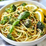 For this recipe, you need 8 ounces of whole grain pasta. Spaghetti or penne works well. Whole grain pasta gives a nutty taste and more fiber. This helps keep you full longer and adds nutrients. When you cook it, follow the package instructions to get it just right. You will need 2 cups of fresh broccoli florets. Look for bright green, firm pieces. Fresh broccoli not only adds color but also packs vitamins. It is a great source of vitamins C and K. You can cut larger pieces into smaller ones for even cooking. Olive oil and garlic are key to flavor. Use 1 tablespoon of olive oil. It adds healthy fats and richness. For garlic, you will need 2 cloves, minced. Garlic brings a warm, savory taste. Sautéing them together creates a fragrant base for your pasta. {{ingredient_image_1}} Start by boiling a large pot of salted water. This adds flavor to your pasta. Once it boils, add 8 oz of whole grain pasta. Cook it based on the package instructions until it's al dente. About 2 minutes before the pasta finishes cooking, toss in 2 cups of broccoli florets. This method cooks the broccoli perfectly. When done, drain both pasta and broccoli together in a colander. Set them aside for later. In the same pot, pour in 1 tablespoon of olive oil and heat it over medium heat. Next, add 2 cloves of minced garlic and ¼ teaspoon of red pepper flakes. Stir them for about 1-2 minutes. This step makes your kitchen smell amazing! Be careful not to burn the garlic; it can turn bitter. After sautéing, return the drained pasta and broccoli to the pot with the garlic. Then, add the zest and juice of 1 lemon. Mix everything well to combine. If you like cheese, sprinkle in ¼ cup of grated Parmesan cheese. Stir until it melts and mixes throughout. Season with salt and pepper to taste. Serve your Healthy Broccoli Pasta right away, garnished with fresh basil leaves. Enjoy this colorful, tasty meal! To make al dente pasta, you need to watch the clock. Follow the package time closely. Taste the pasta before it’s done. It should be firm but not hard. About two minutes before the time is up, add the broccoli. This way, both will cook perfectly together. Lemon adds a bright taste to your dish. Use both the zest and the juice. Zest before you cut the lemon. This makes it easier to get all the zest. Mix the lemon zest in with the pasta after cooking, then add the juice. It will wake up the flavors. Serve this dish hot and fresh. Garnish it with fresh basil leaves for color. If you like cheese, sprinkle on some grated Parmesan. You can also add extra red pepper flakes for spice. This meal is great on its own or paired with a side salad. Pro Tips Cooking Pasta Perfectly: Ensure you salt the water generously before adding the pasta; it enhances the flavor and helps prevent sticking. Freshness is Key: Use fresh broccoli for the best texture and flavor; frozen broccoli can become mushy when cooked. Customize Your Cheese: For a vegan option, replace Parmesan with nutritional yeast or a plant-based cheese to maintain a cheesy flavor without dairy. Enhance Your Dish: Add toasted pine nuts or walnuts for a crunchy element, giving your pasta a delightful texture and nutty flavor. {{image_2}} If you want a vegan version, skip the cheese. You can use nuts for creaminess. Try cashews or almonds blended with a bit of water. Nutritional yeast is another great substitute. It adds a cheesy flavor without dairy. You can also mix in a plant-based cheese if you prefer that taste. For gluten-free pasta, choose options made from rice or corn. Many brands offer tasty alternatives. Look for pasta labeled "gluten-free" at your local store. Cook it just like regular pasta. Follow the package instructions for the best results. This way, everyone can enjoy the dish! Adding protein makes this dish heartier. For a meat option, try grilled chicken. Cook the chicken separately, then slice and mix it in at the end. If you prefer plant-based protein, tofu is a great choice. Press and cube the tofu, then sauté it until golden. Add the tofu to the pasta before serving for a filling meal. To keep your healthy broccoli pasta fresh, place it in an airtight container. Make sure to cool the pasta to room temperature first. Store it in the fridge for up to three days. Label the container with the date to track freshness. When you're ready to enjoy your leftovers, reheat them gently. You can use a microwave or a stovetop. If using a microwave, heat in short bursts to avoid overcooking. For the stovetop, add a splash of water or oil to help steam the pasta. Heat until warm, stirring often. If you want to freeze your broccoli pasta, do it right after cooking. Place it in a freezer-safe container. It can last up to three months in the freezer. When ready to eat, thaw it overnight in the fridge. Reheat it on the stovetop for best results. Broccoli is a superfood packed with nutrients. It is low in calories but high in fiber. This helps keep you full and aids digestion. Broccoli is rich in vitamins C and K. Vitamin C boosts your immune system. Vitamin K is vital for bone health. It also contains antioxidants, which fight free radicals. Eating broccoli can support heart health and may lower cancer risks. Yes, you can use frozen broccoli. It is a great time-saver and still healthy. Just add it directly to the boiling pasta water. Cook it for about two minutes before draining. Frozen broccoli is often picked at peak freshness, preserving nutrients. This makes it a good option when fresh broccoli isn't available. To spice up your broccoli pasta, add more red pepper flakes. Start with a pinch and taste as you go. You can also add crushed red pepper for extra heat. If you like, include diced jalapeños or fresh chili peppers. For a smoky flavor, try smoked paprika. Just remember to balance the spice with lemon juice or cheese. This blog post showed you how to make a simple, tasty dish using whole grain pasta and fresh broccoli. I shared tips to cook the pasta just right and enhance flavor using lemon and garlic. You learned about options for vegan or gluten-free choices and how to store leftovers. Remember, good food can be quick and healthy. Enjoy making this meal, and feel free to mix it up. Happy cooking!